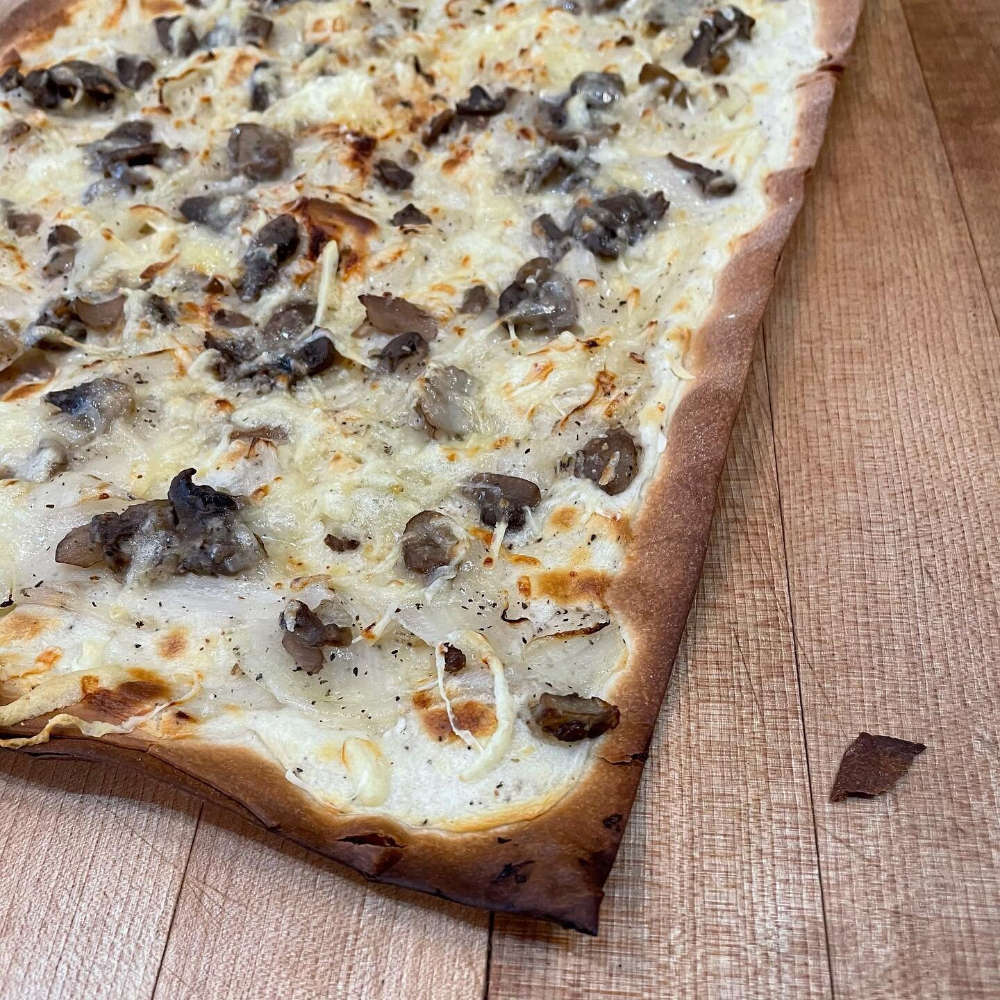 Just trying to stay warm or planning on watching the super bowl, the tarte flamb&eacute;e is the perfect dish for such a cold Sunday! Pictured is the new version now available: creme fraiche, onions, comte cheese, and mushrooms. It is vegetarian and 