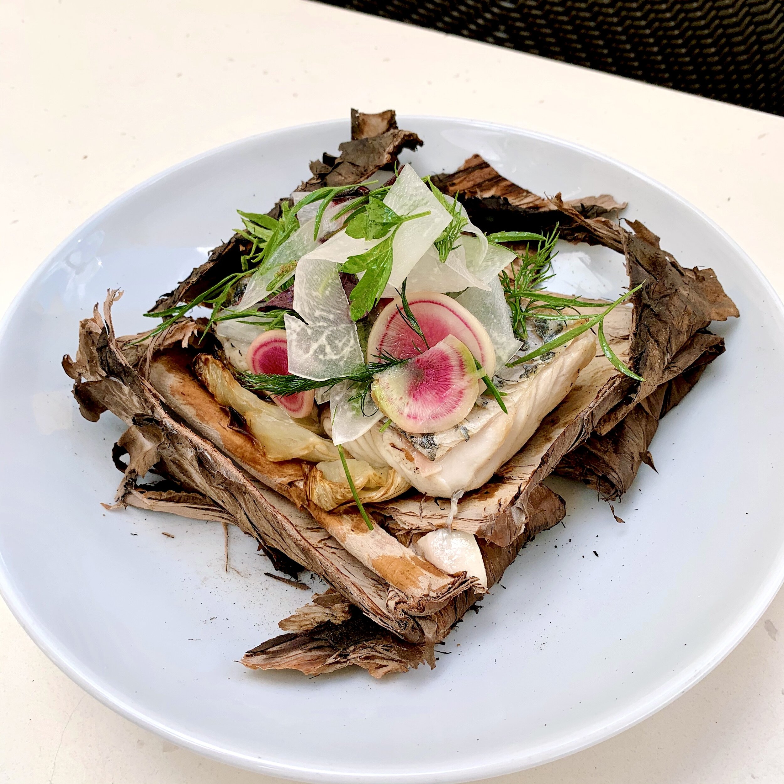 Barramundi fillet baked in paperbark, kohlrabi & sea celery salad
