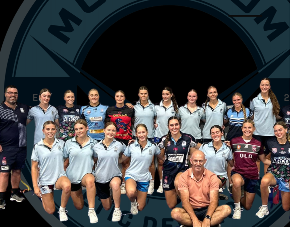 Group photo of female athletes and their coaches, some wearing team uniforms, in front of a Marymount athletics logo, with text "Marymount Athletes" at the bottom.