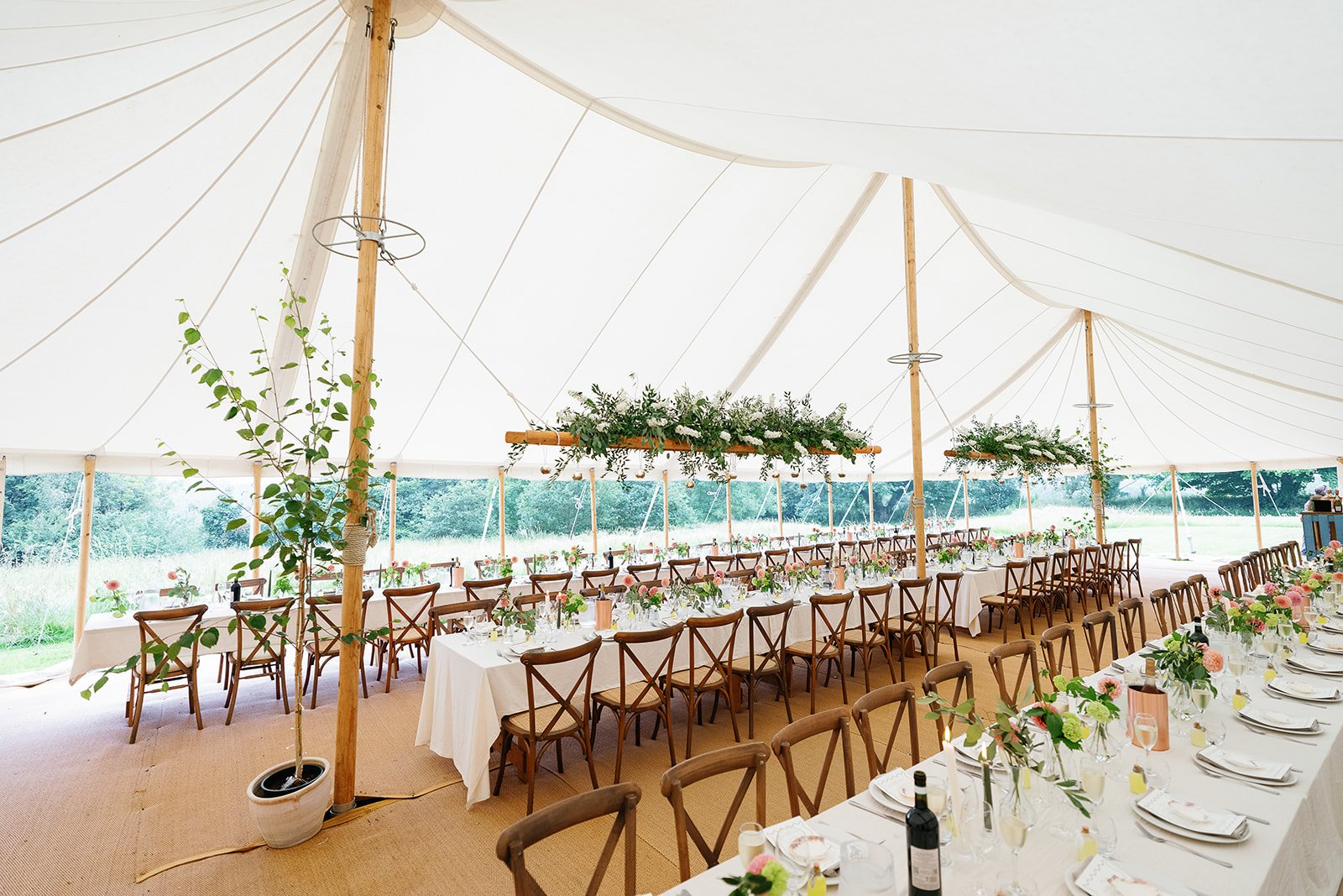 Marquee set up on meadow at exclusive-use country estate Boconnion in Cornwall