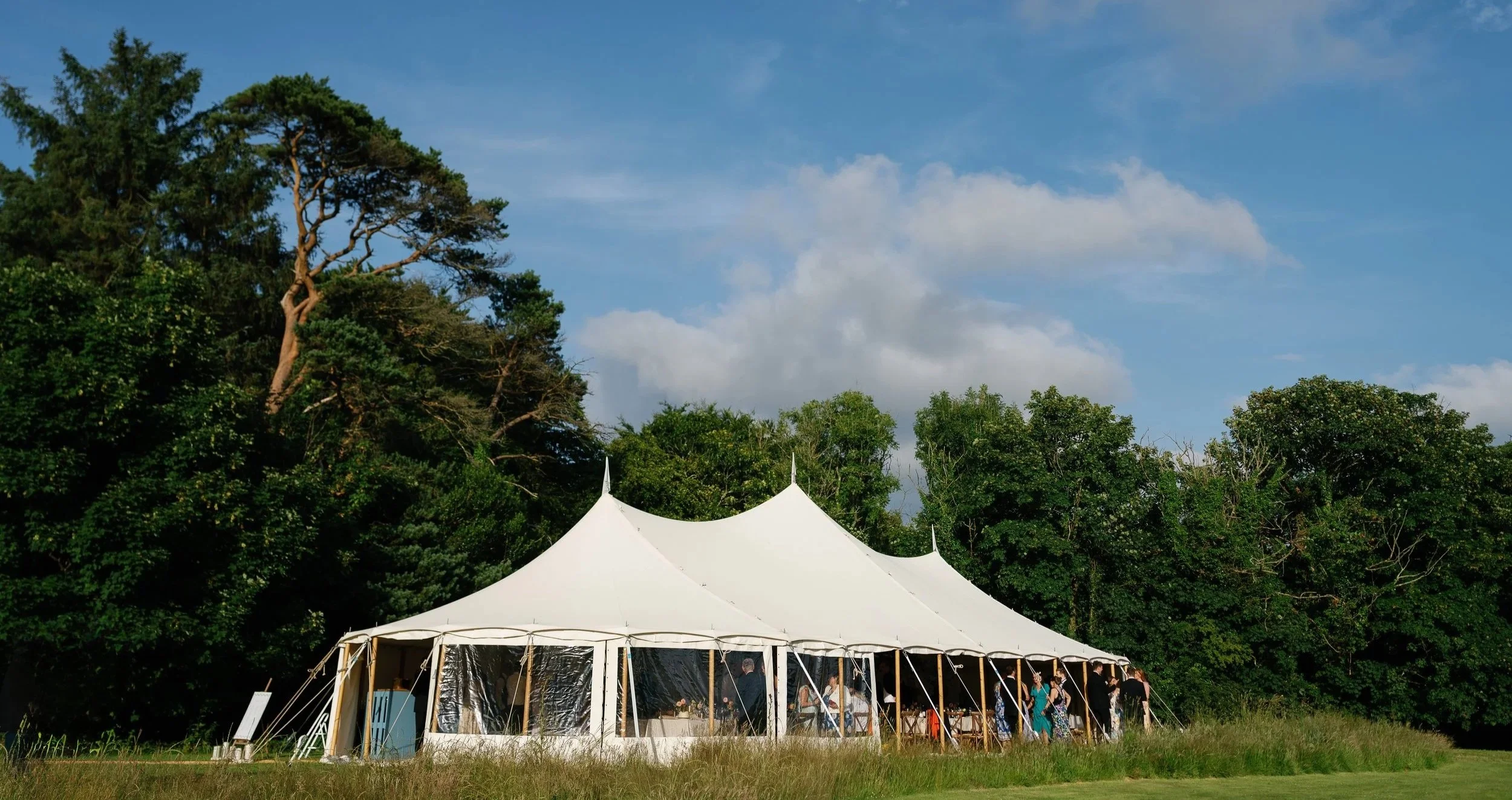 Marquee wedding at Boconnion, Cornwall on an open meadow in the summer