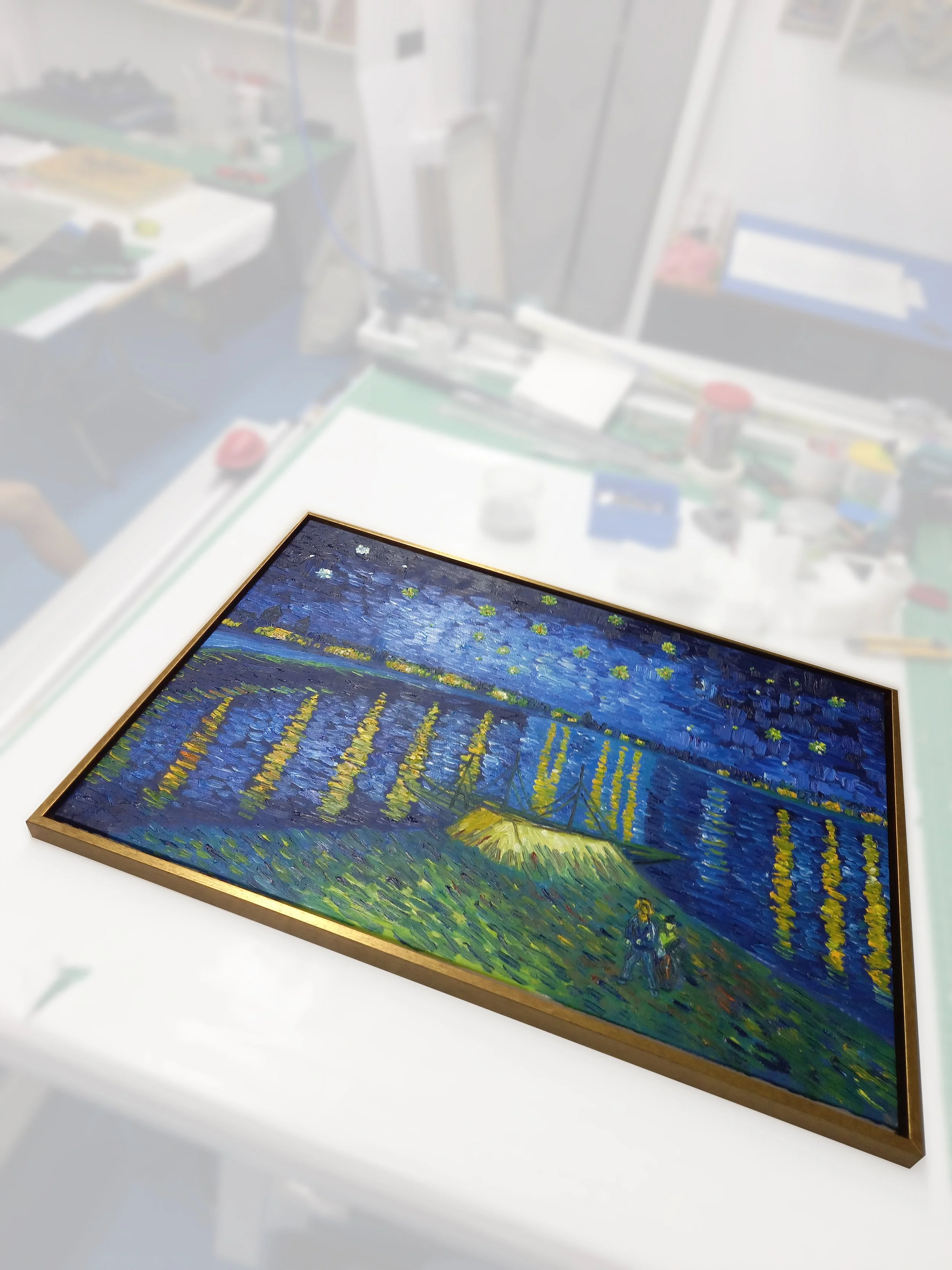 A framed painting of a night-time landscape with a starry sky, a crescent moon, water lilies in a pond, and RFRA written in yellow on the water.