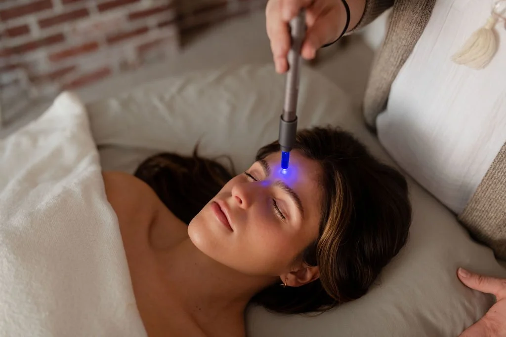 Woman relaxed with eyes closed during chromotherapy