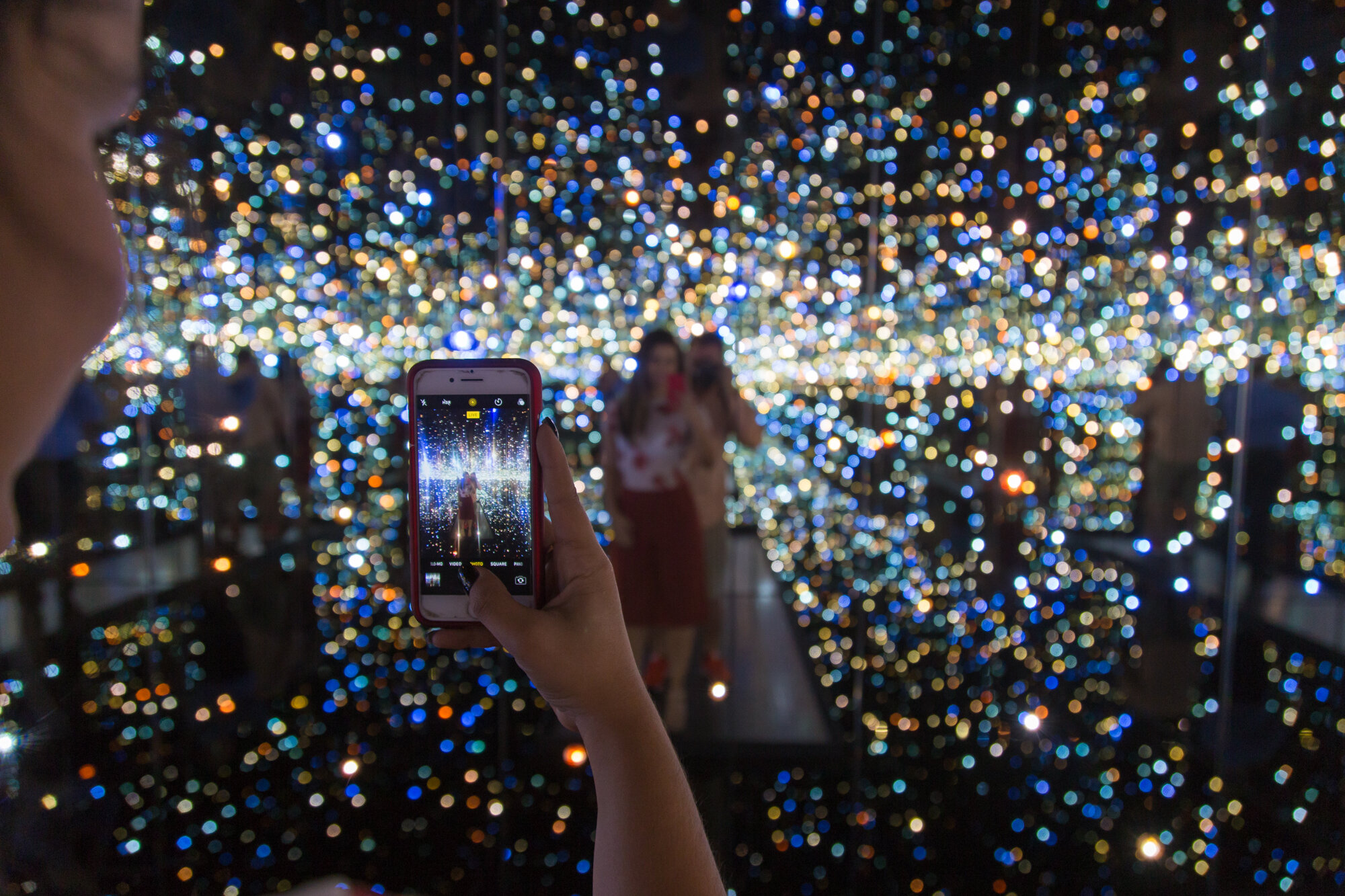 People use their smartphones to take pictures of the Yayoi Kusama