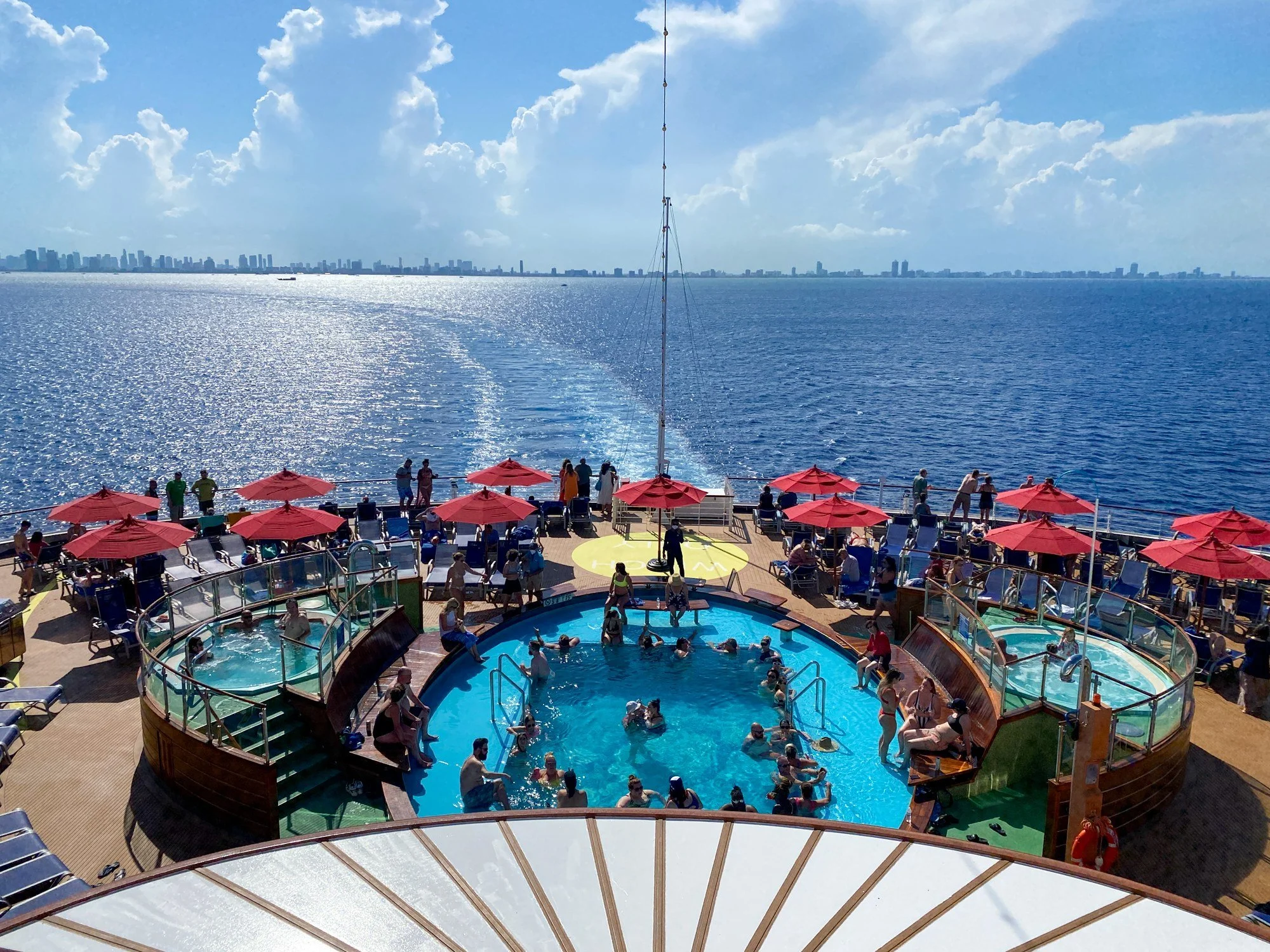 Guests gathered around the Lido Deck pool aboard Carnival Horizon