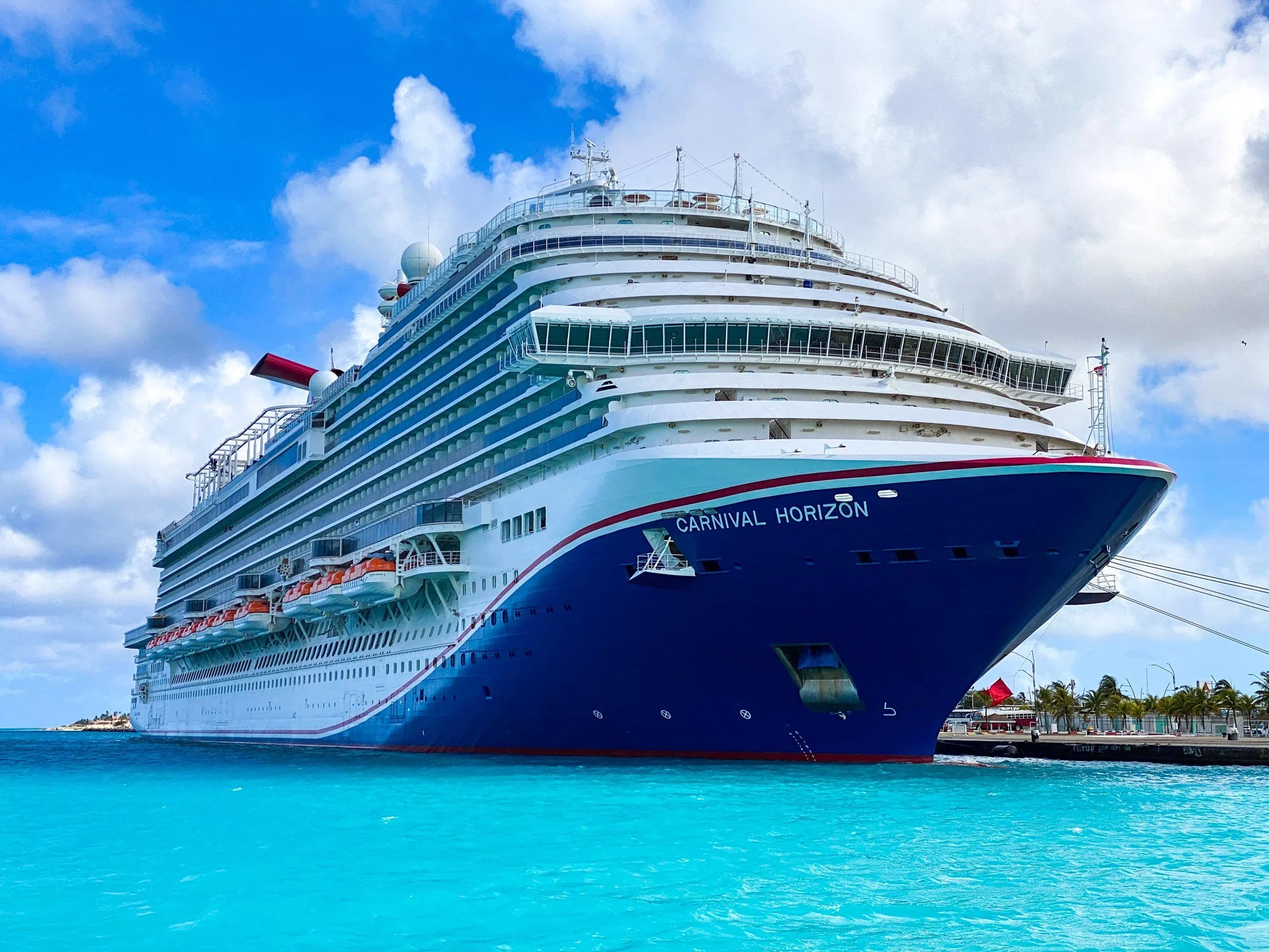 Carnival Horizon docked in Aruba beneath a bright blue sky