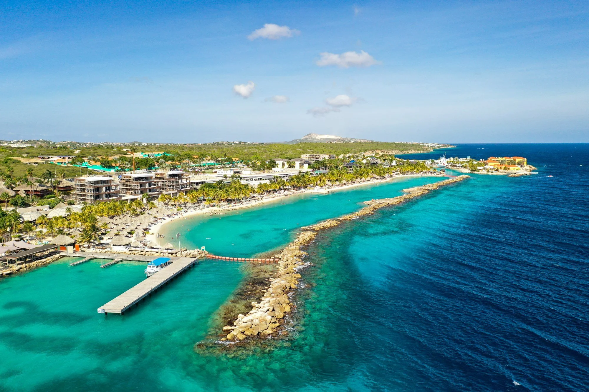 Aerial view of a turquoise lagoon and resort on the Curaçao coast