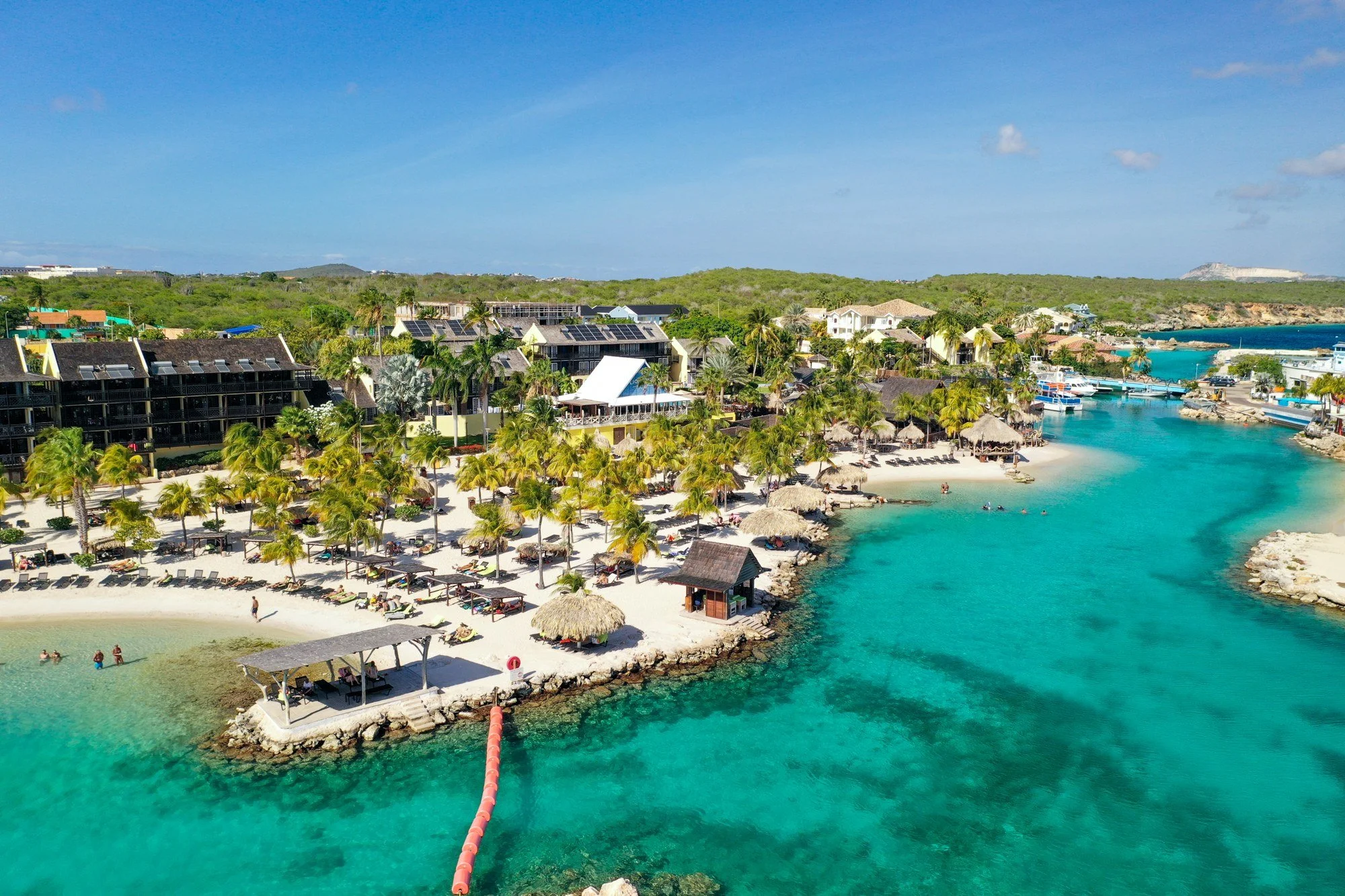 Beach resort and clear turquoise lagoon viewed from above in Curaçao