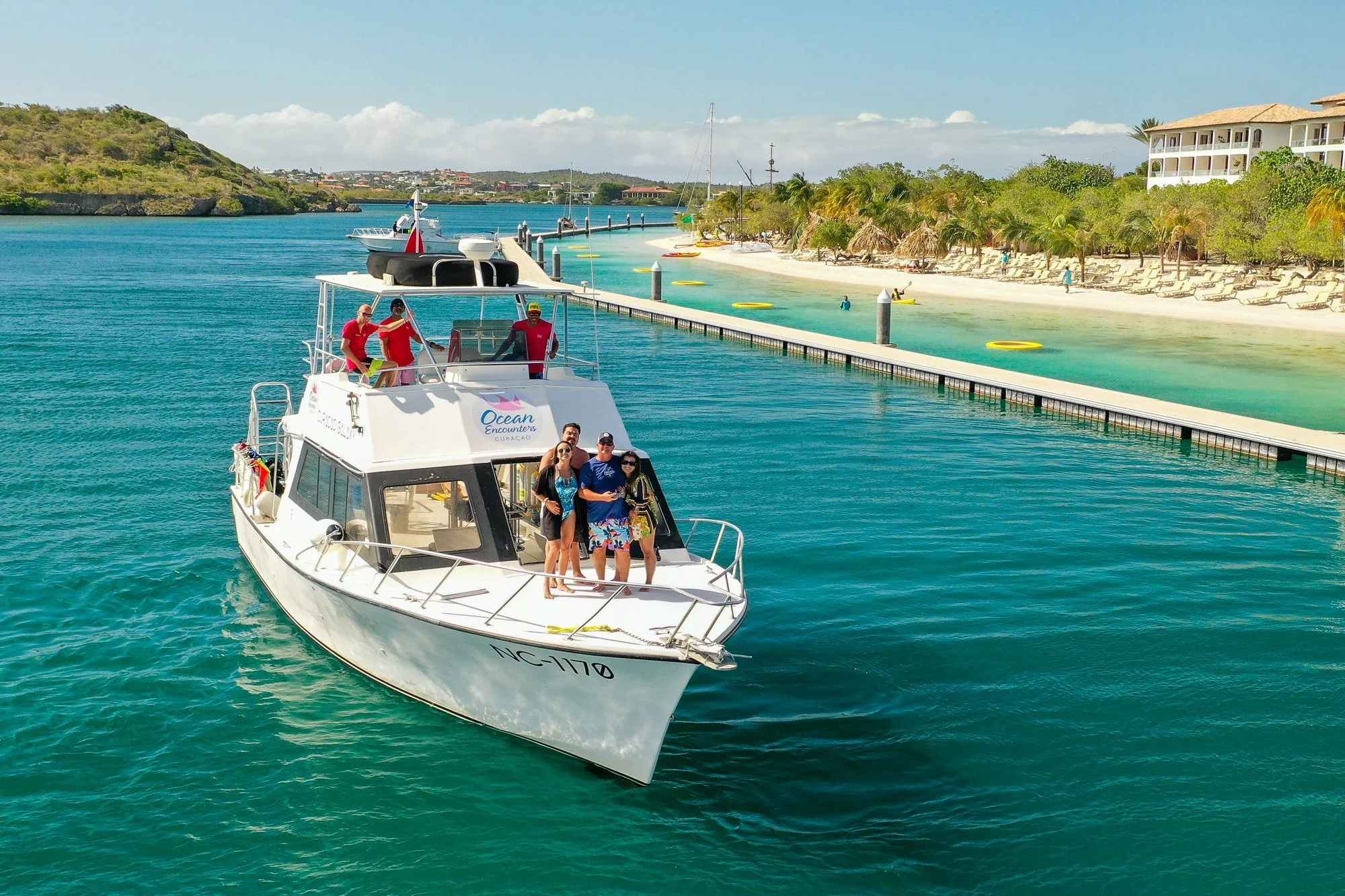 Galaxy dive boat on turquoise water beside a pier in Curaçao