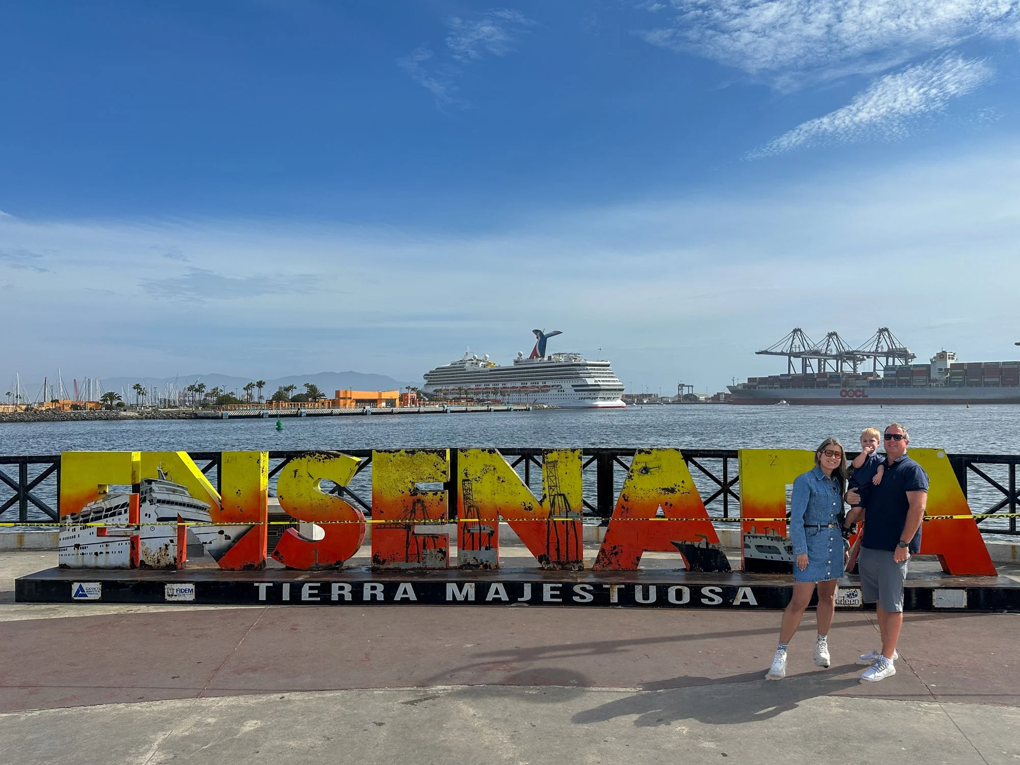 Jason and Amanda at the Ensenada waterfront sign with Carnival Radiance in the background.