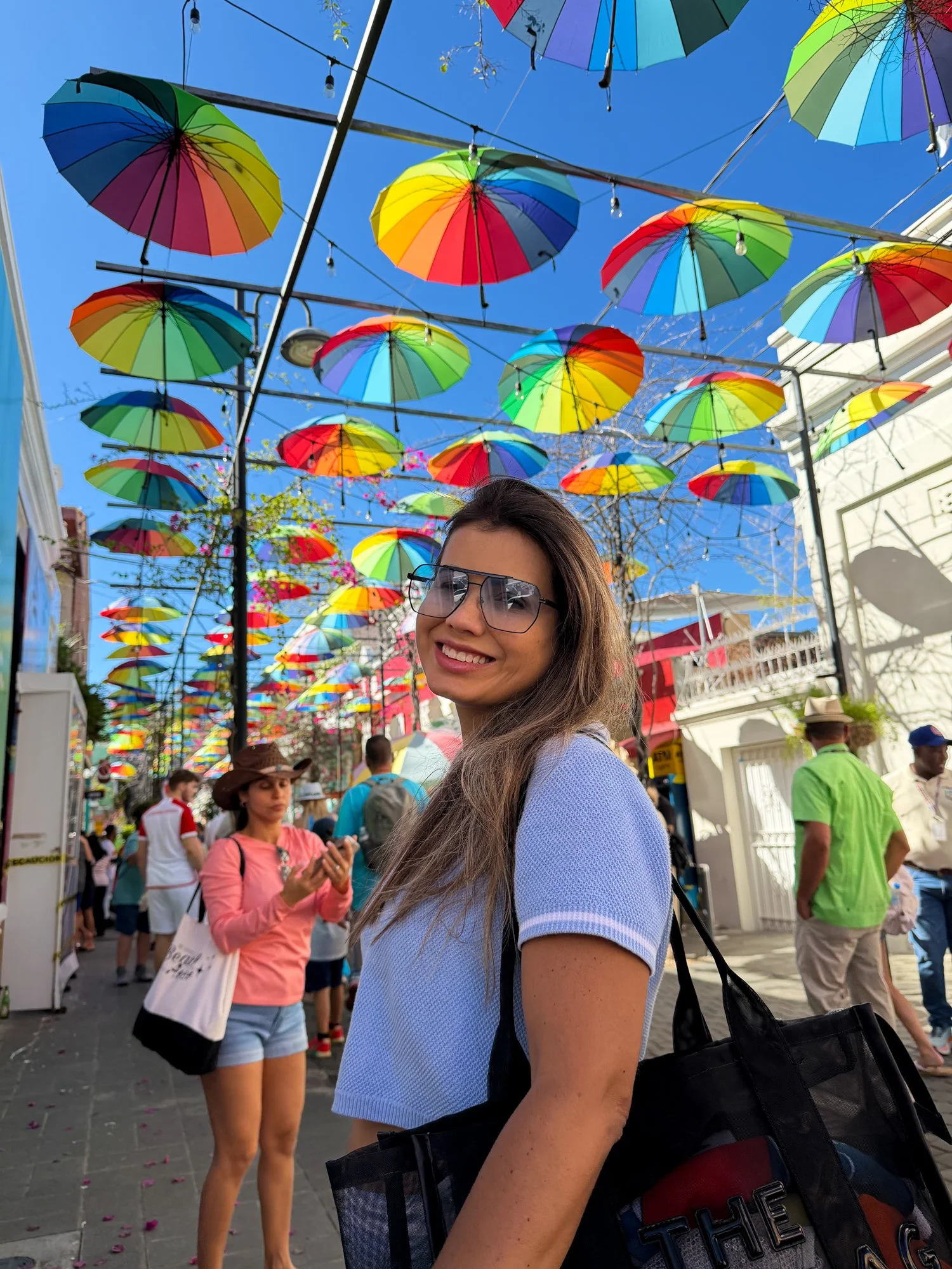 Portrait beneath a canopy of colorful umbrellas at Taino Bay in Puerto Plata.