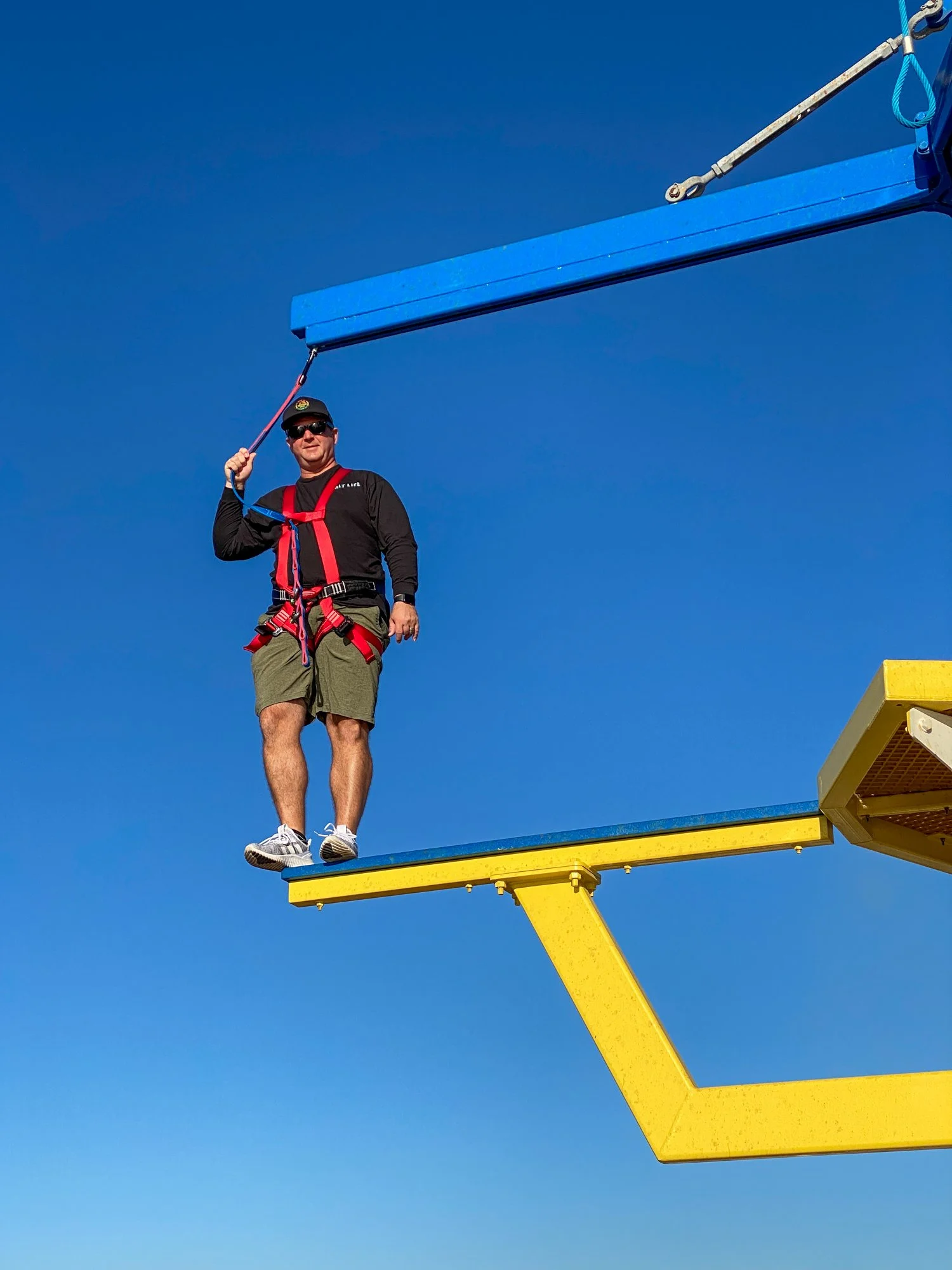 Jason crossing the ropes course high above the deck of Carnival Radiance