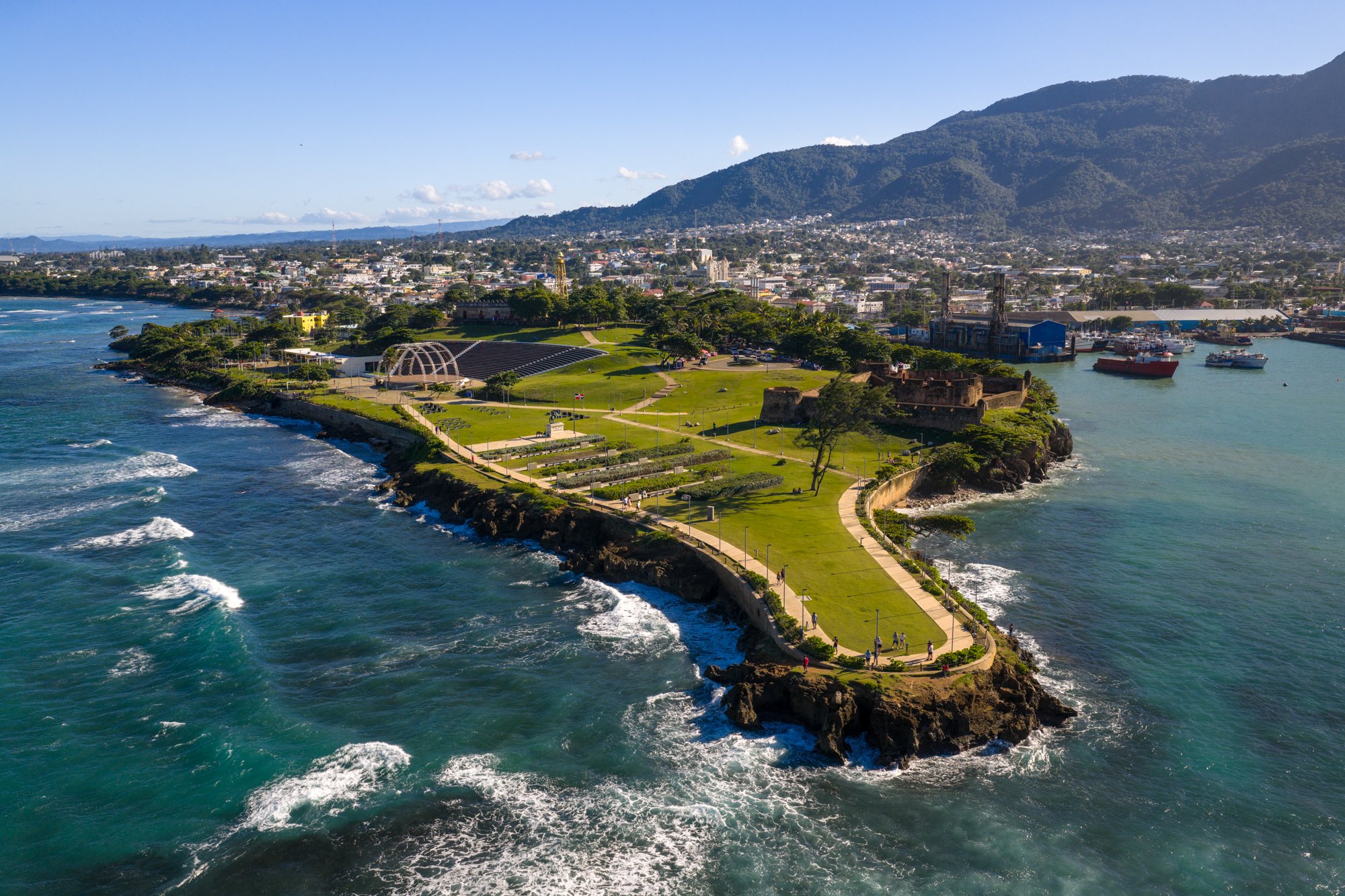 Aerial view of Fortaleza San Felipe on Puerto Plata’s waterfront with the city and mountains beyond.