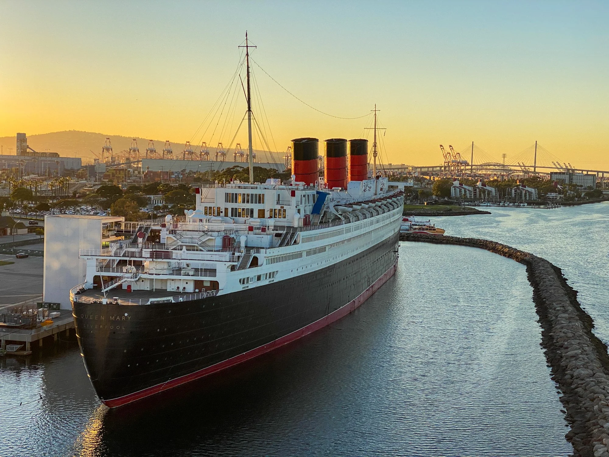 Queen Mary at sunset viewed from a Carnival Radiance balcony in Long Beach