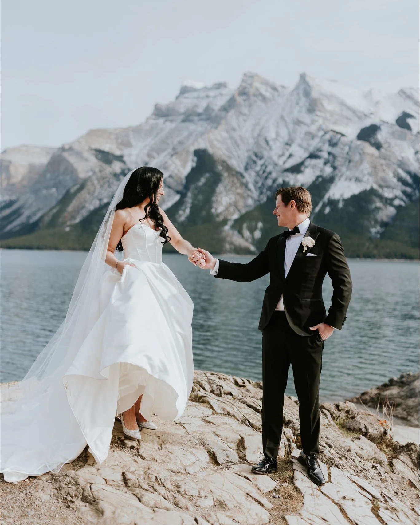 A quiet moment, a breathtaking backdrop, and a love that says it all. Some love stories are meant to be framed by the Rockies.