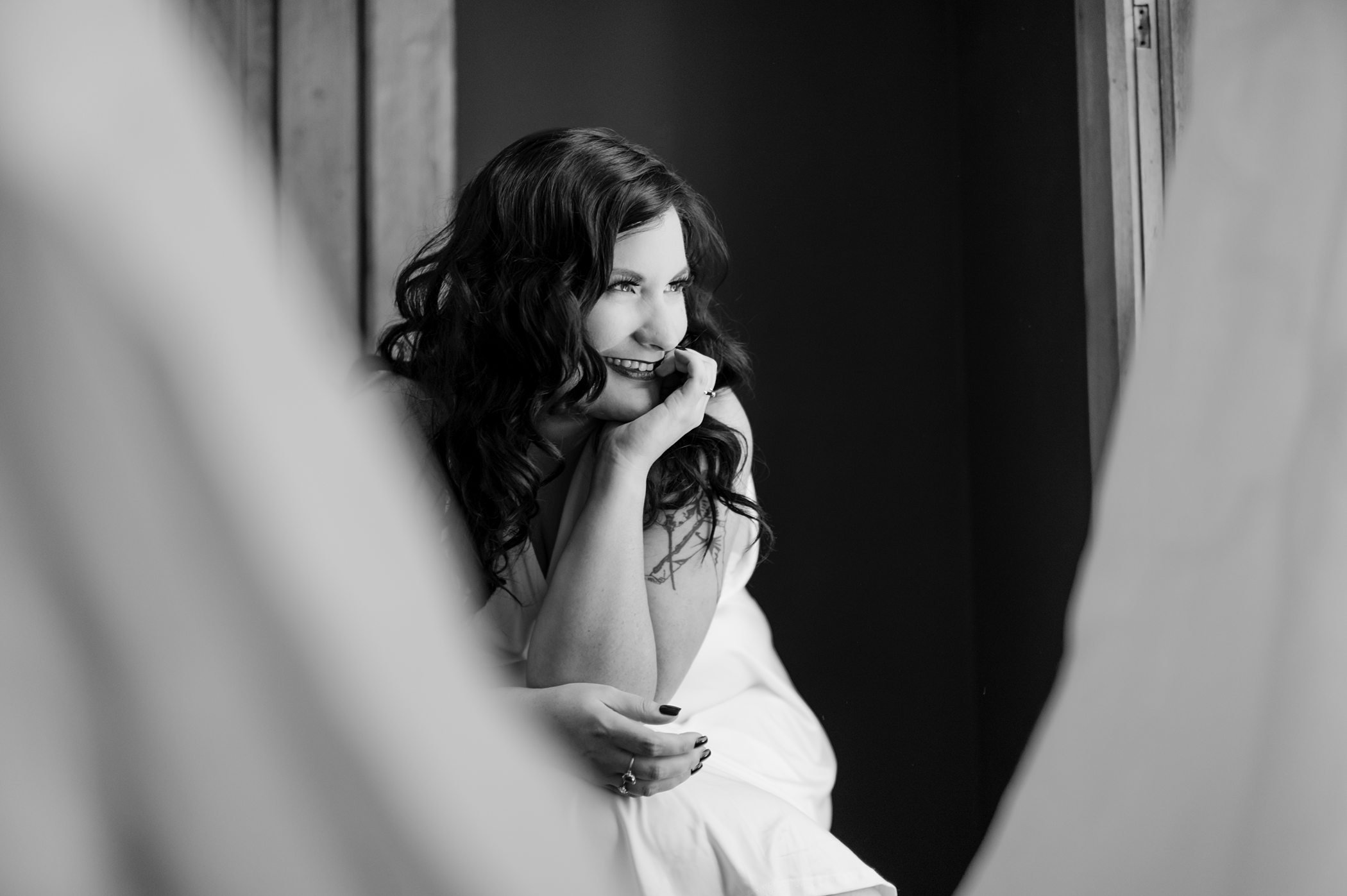 black and white boudoir photo of woman smiling and being happy again in michigan