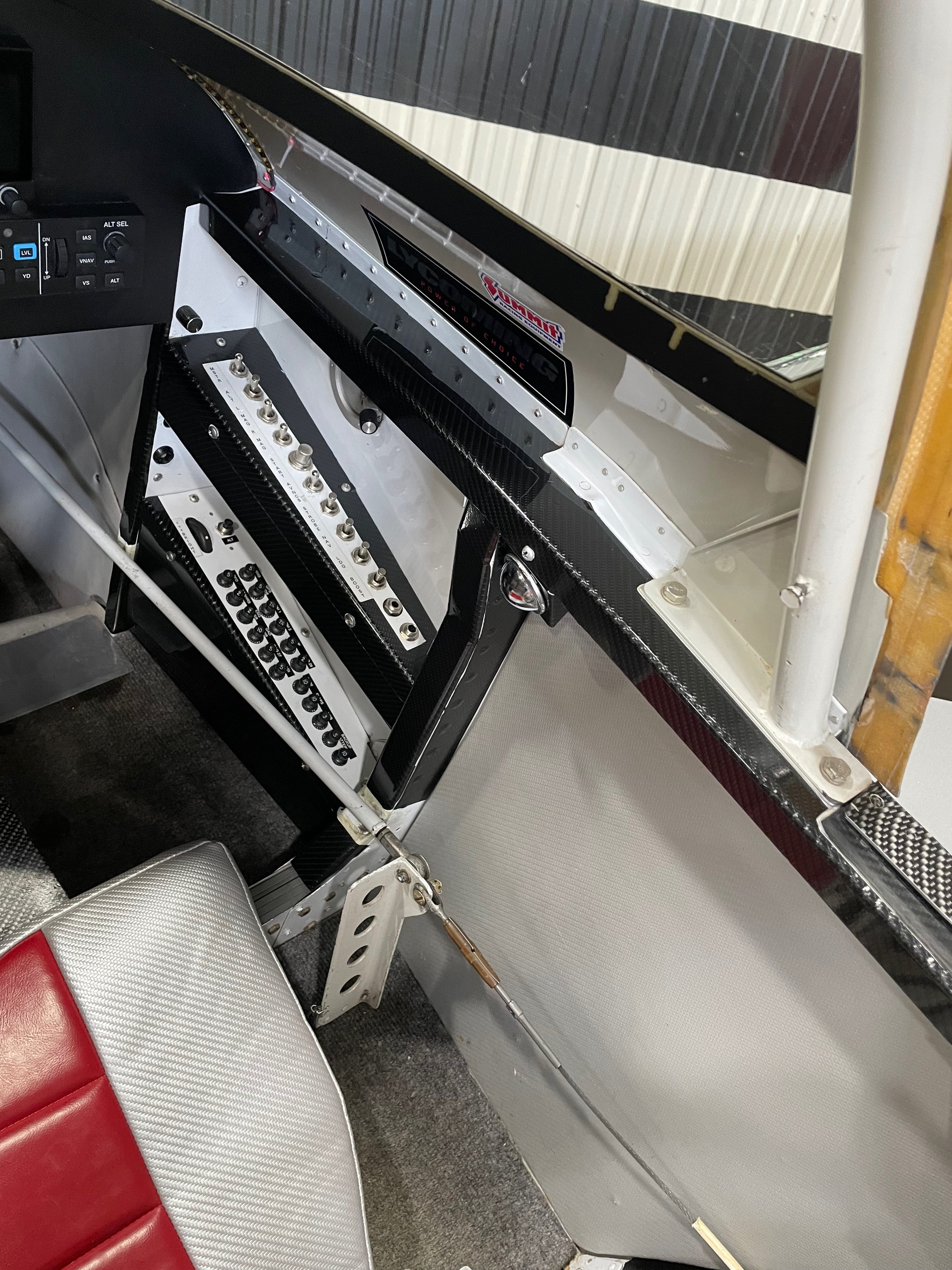 Interior of aerobatic aircraft with numbered switches and buttons.