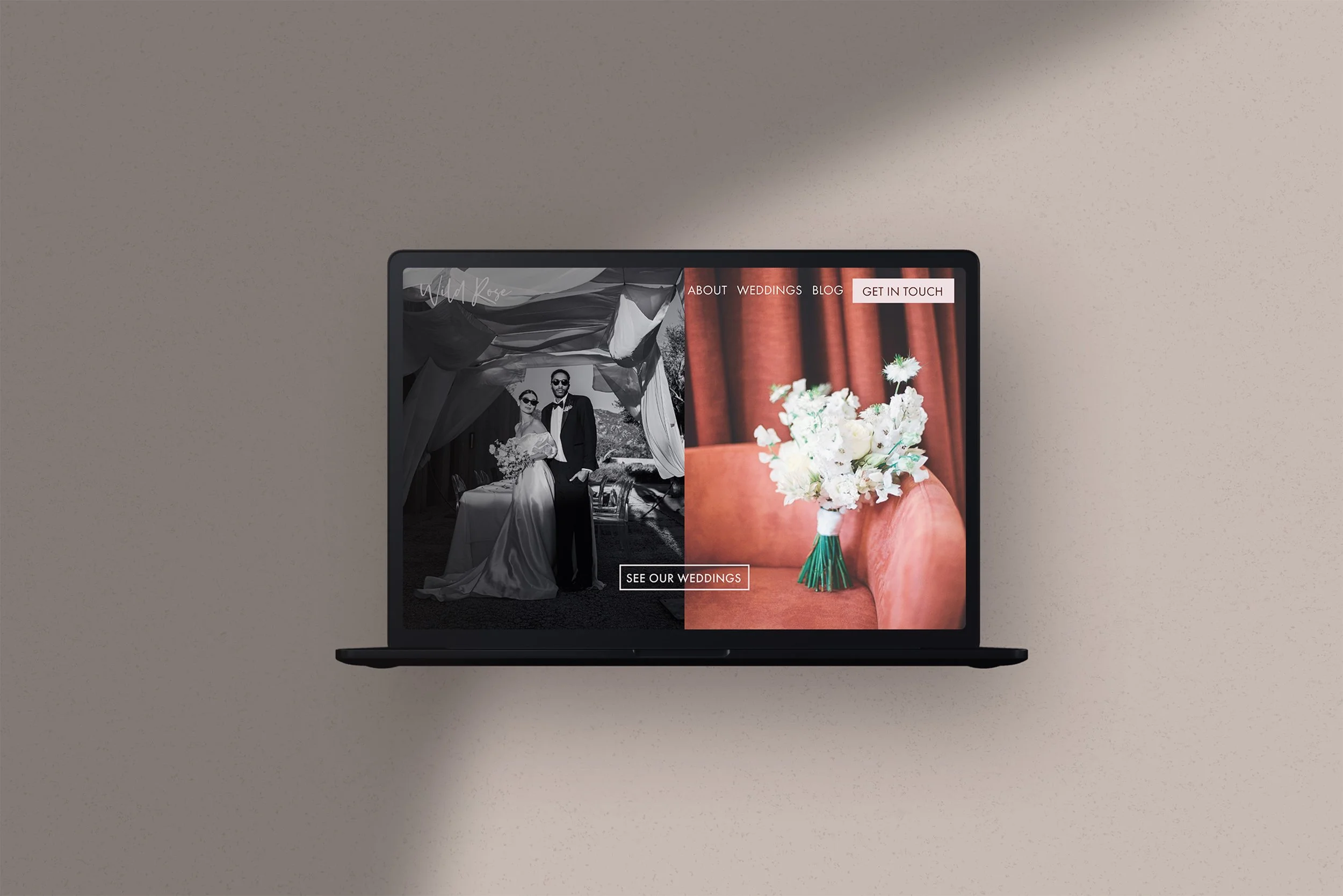 Laptop screen displaying wedding website with black and white image of bride and groom on left and color image of flower arrangement on right.