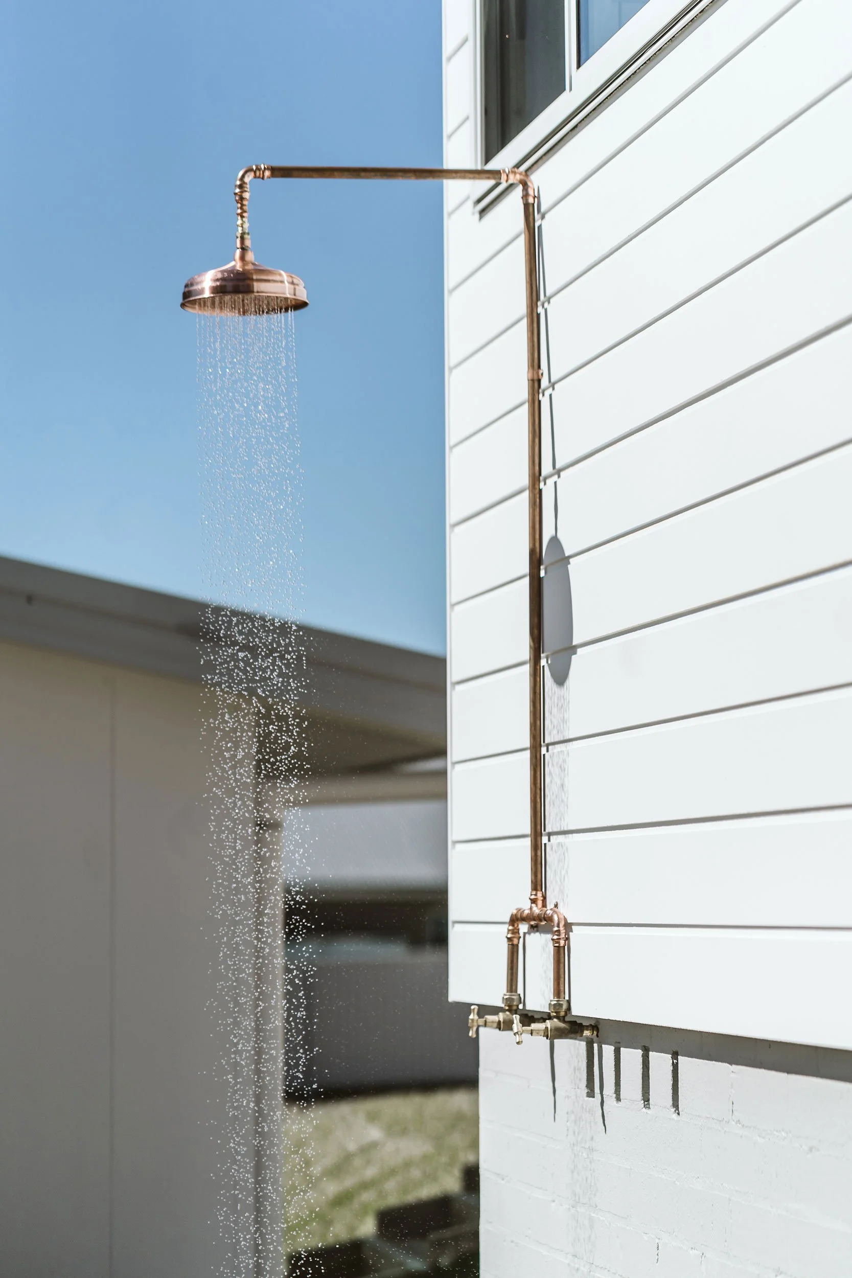 Outdoor shower in custom home build Manyana