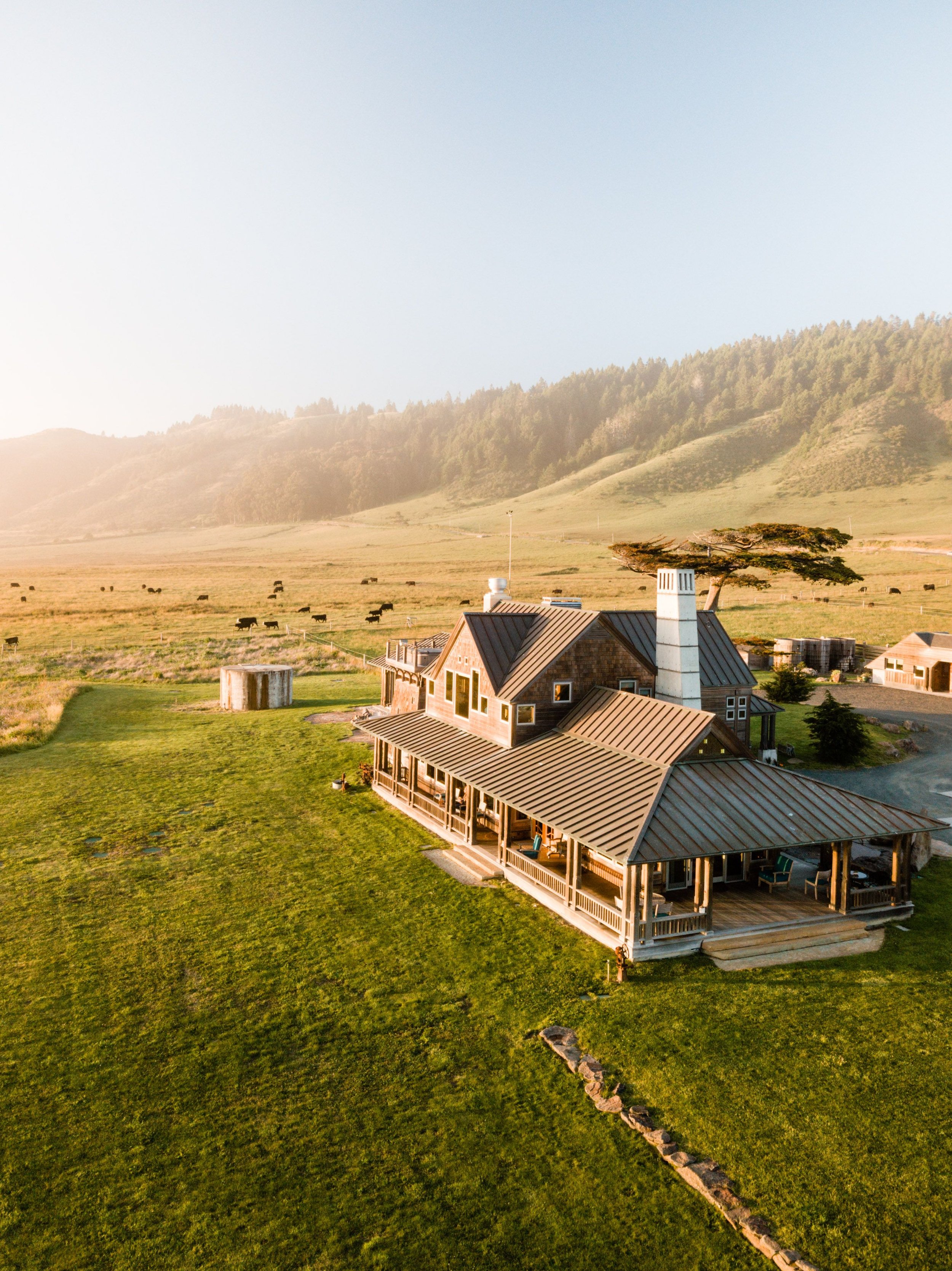 Sundrenched aerial of The Inn at Newport Ranch with vibrant green grass