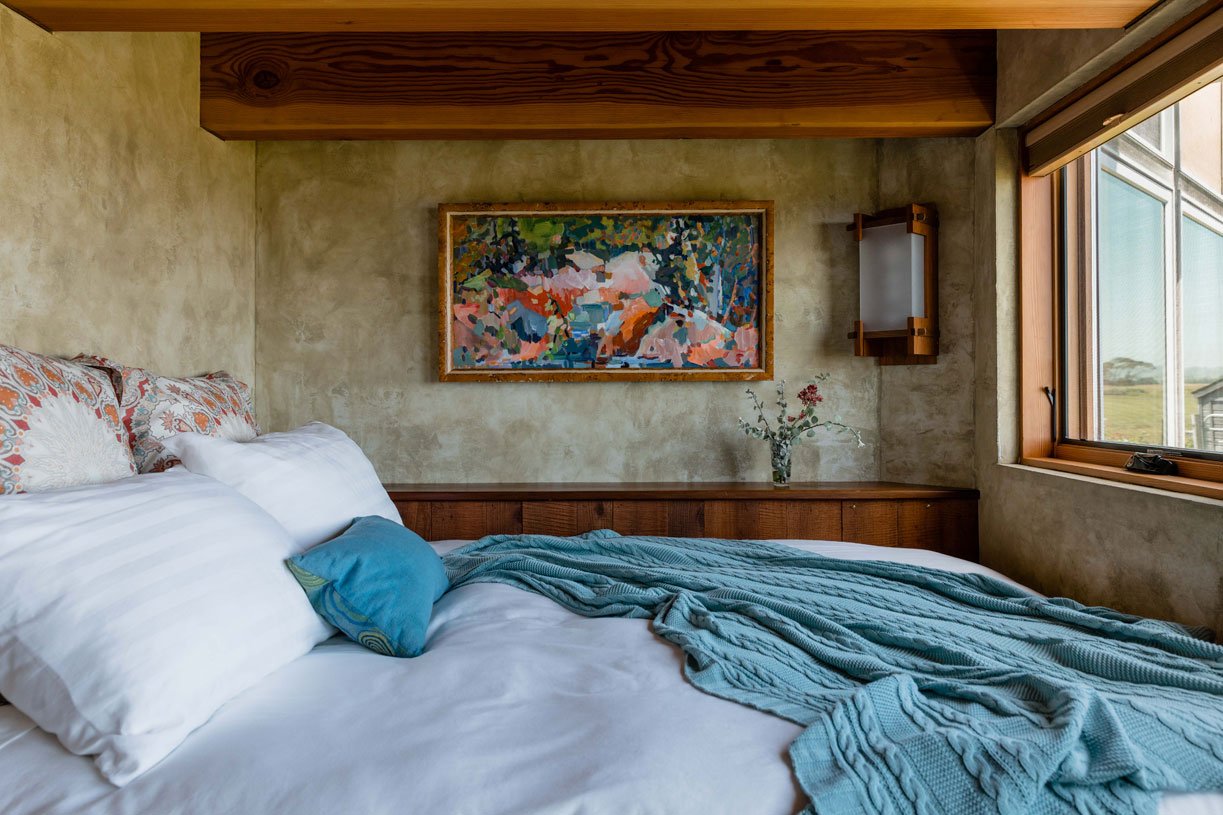 Charming 2nd guest bedroom with colorful painting, cozy linens and a wide view of the ocean