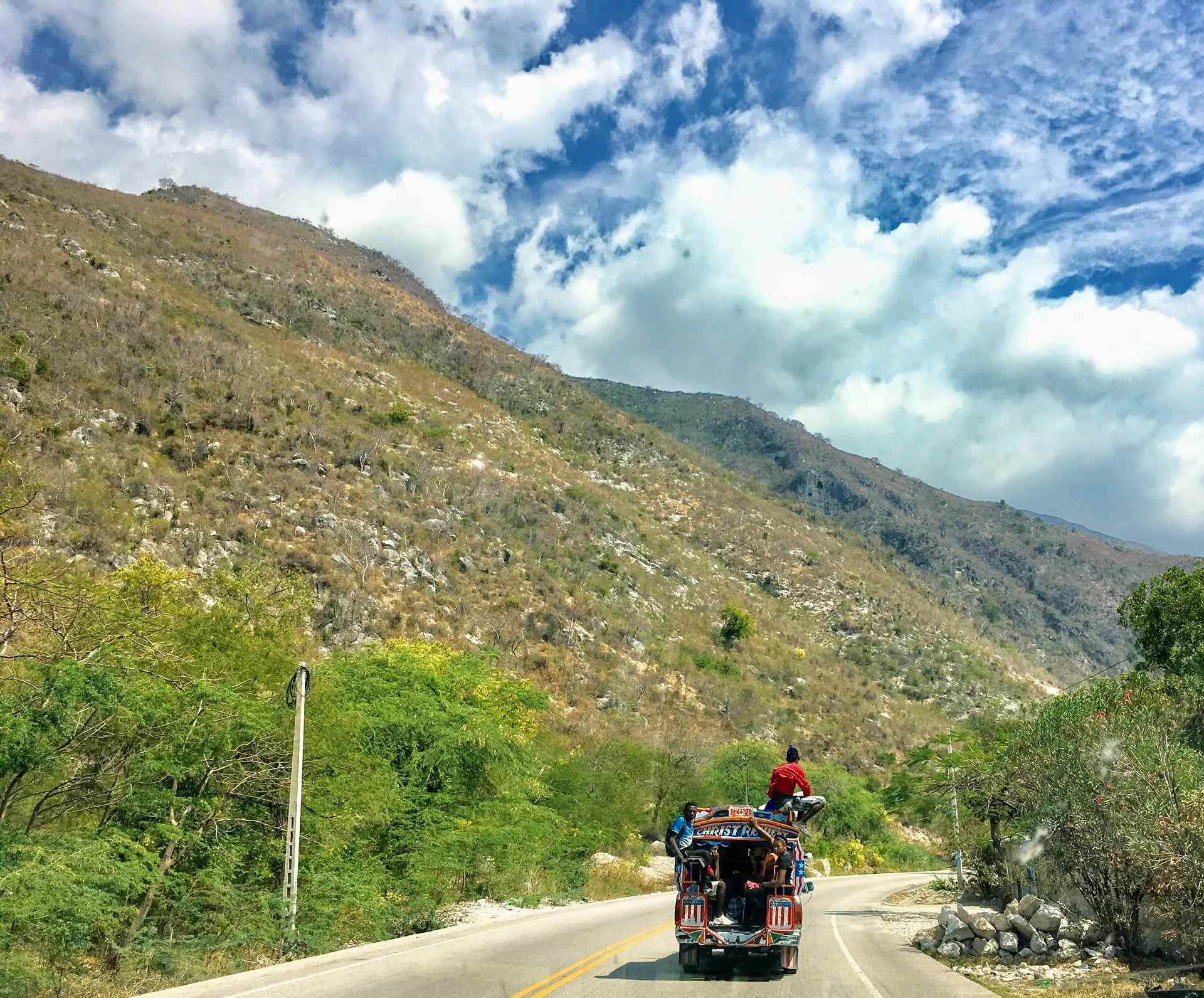 Tap Tap 🚌.
The colorful truck in this image is a tap tap, a unique form of public transportation in Haiti. "Tap tap" means "quick quick" in Haitian Creole. These vehicles are often brightly painted with intricate designs, religious symbols, and popu