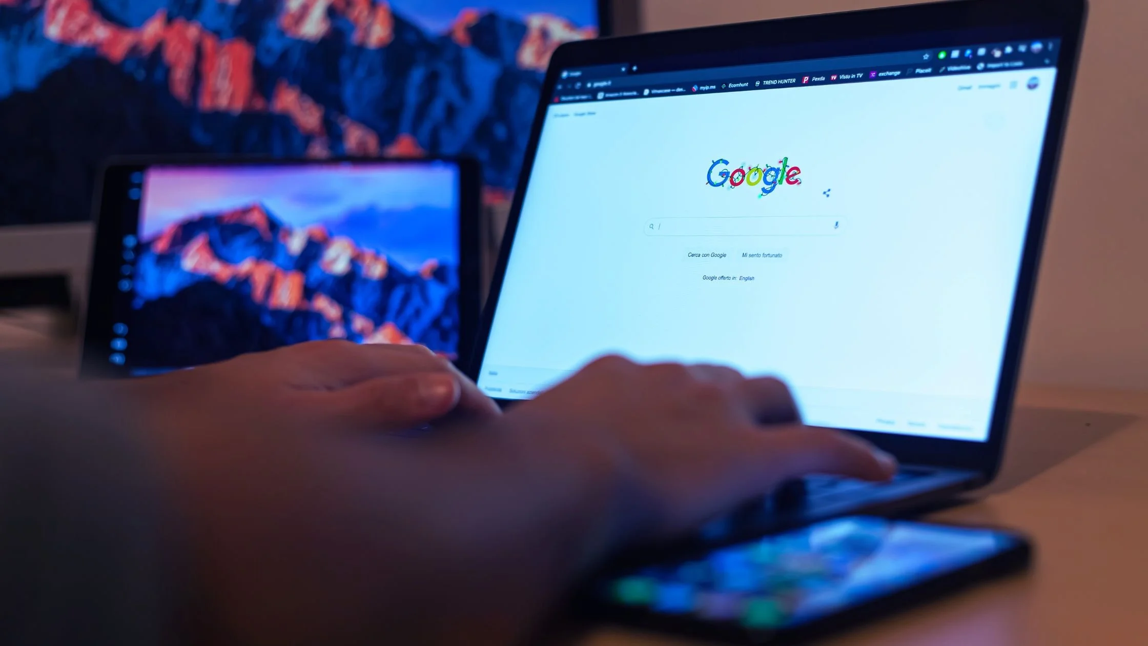 Person using Google search on a laptop to research property services and real estate information online for selling a home.