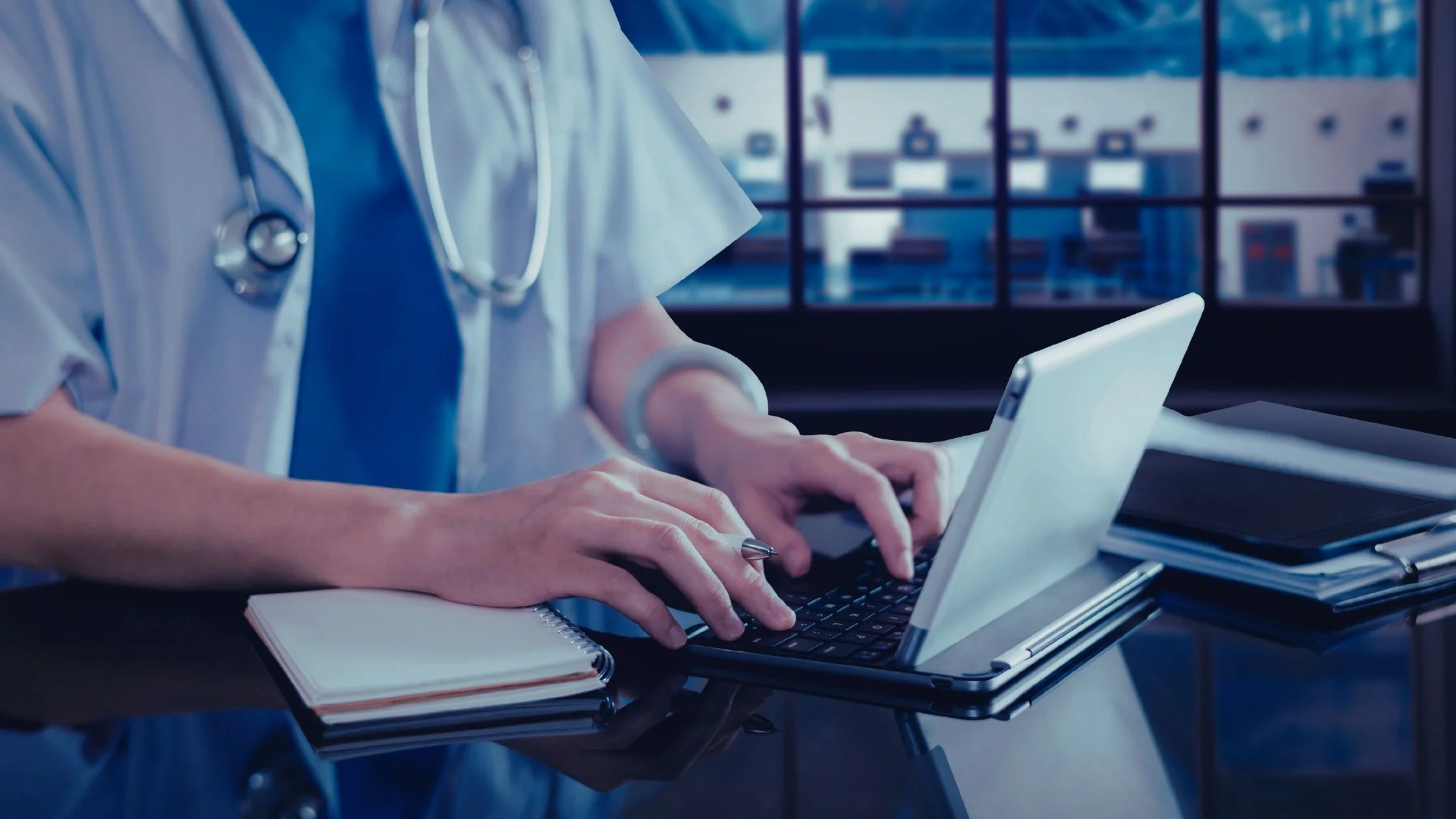Healthcare professional using a tablet to manage patient information and healthcare services online in a modern medical clinic.