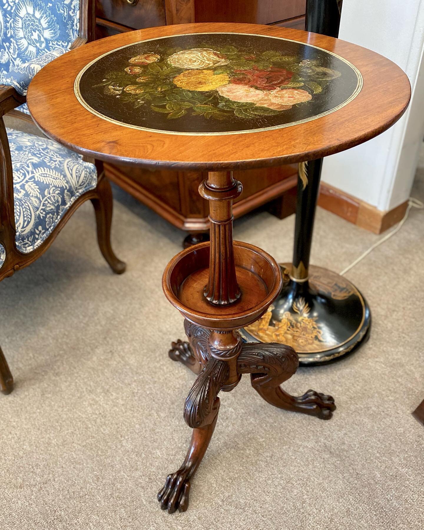 A delightful 19th century carved tripod base wine table, features a turned tray to the column, claw feet and an oil floral insert to the top.