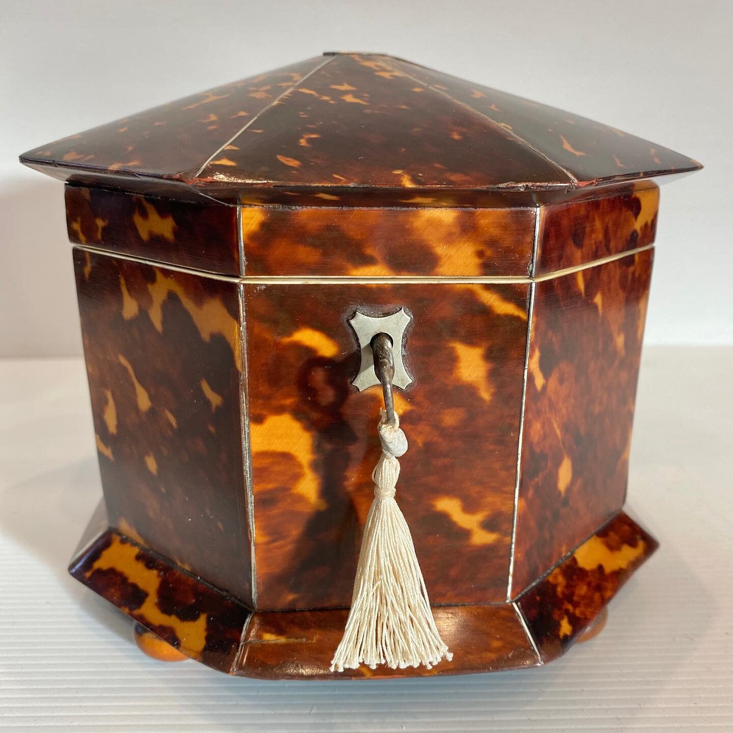 A recent restoration of this gorgeous 19th century tortoise shell octagonal shaped tea caddy with silver stringing and ivory trimming.