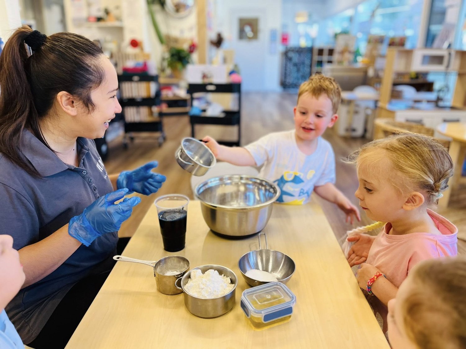 Children taking part in food preparation with a BEL educator