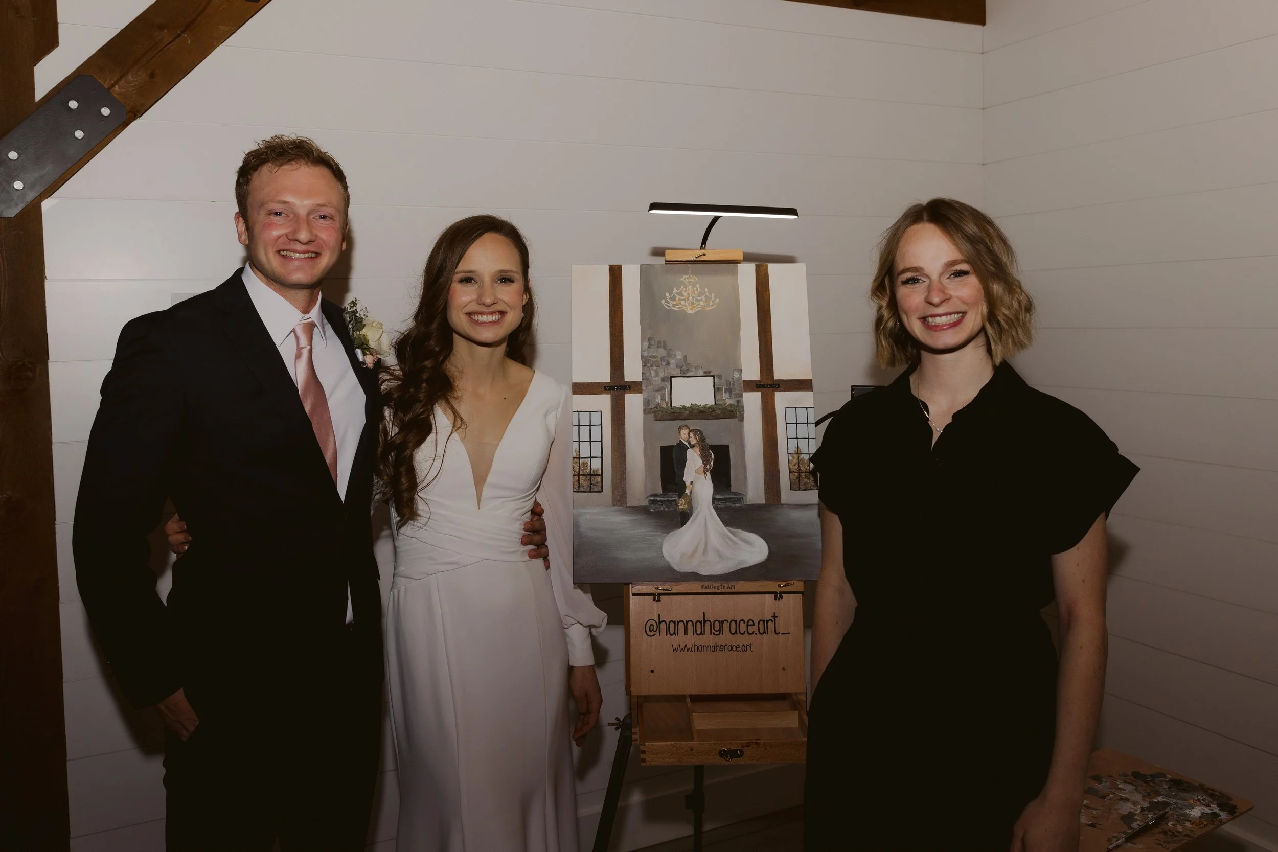 Mountain range with brown peaks in the distance and green rolling hills in the foreground under a clear sky.