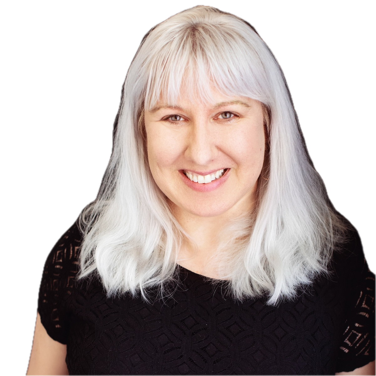 Kerry Savage profile picture - A smiling woman with long white hair, wearing a black top with lace-like patterns, against a black background.