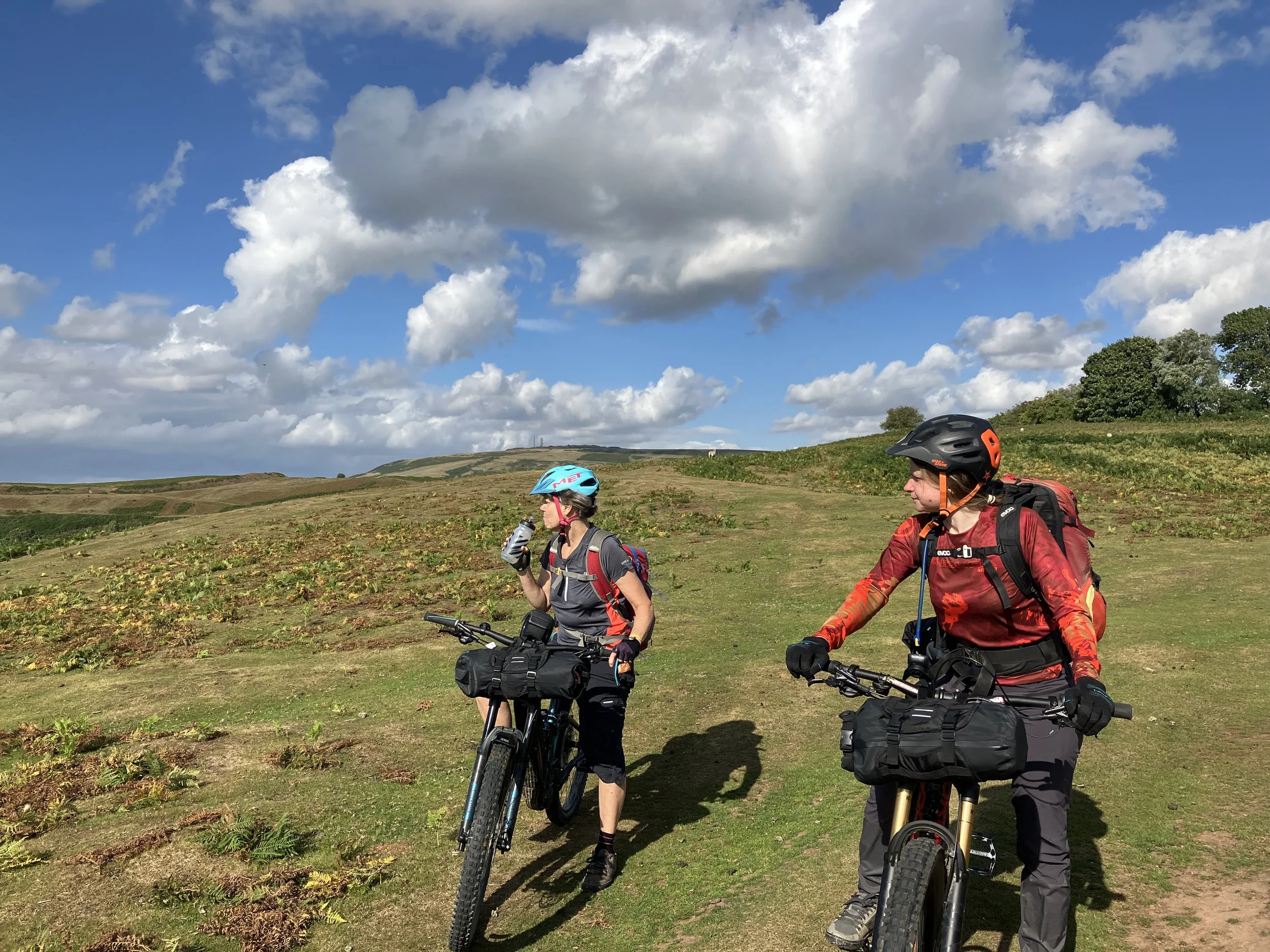 Two women bikepacking looking out at a view