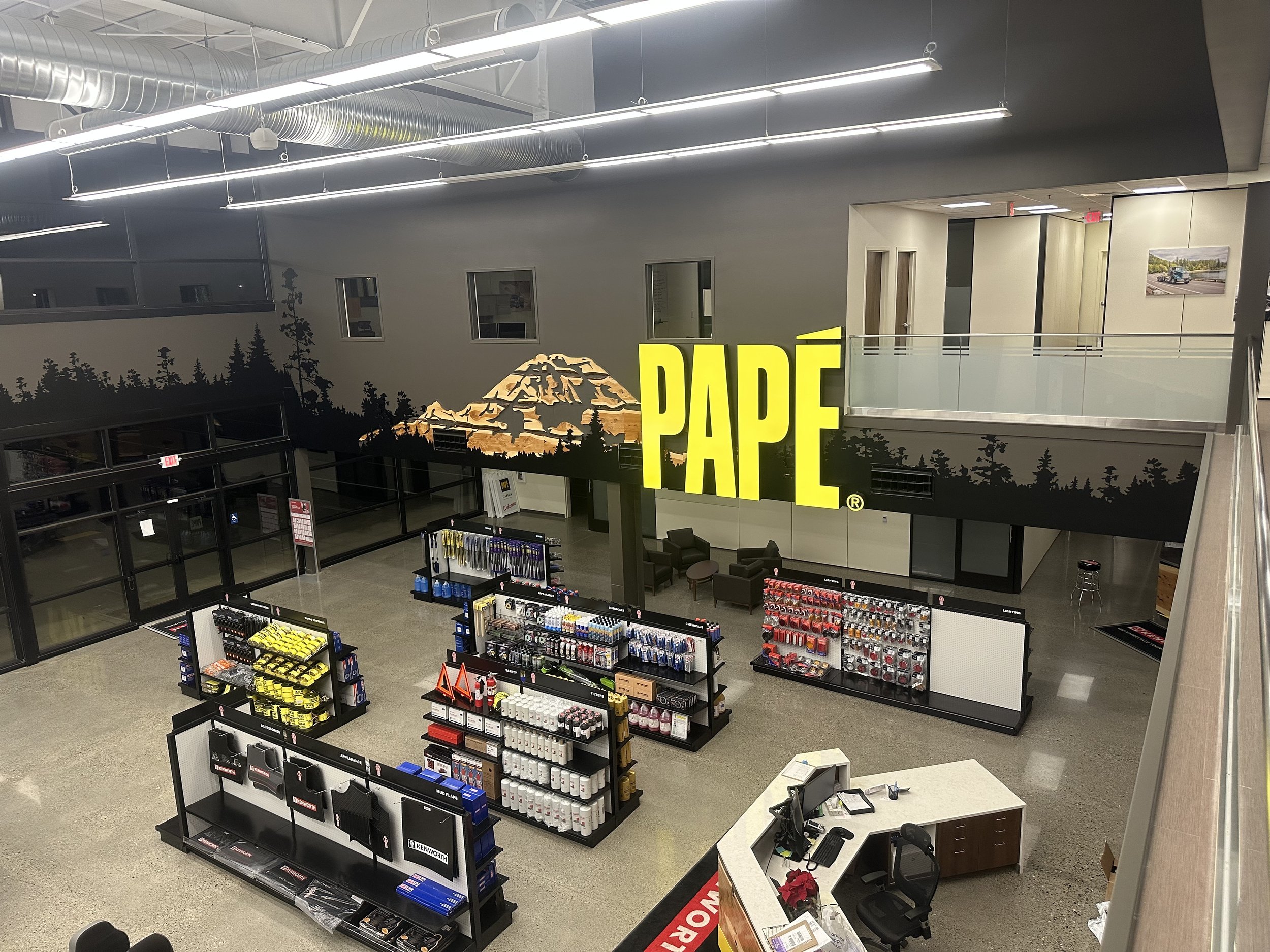 Seven foot tall, internally lit signage. Mixed media landscape of centra, slabs of juniper and vinyl.—Federal Way, WA. 