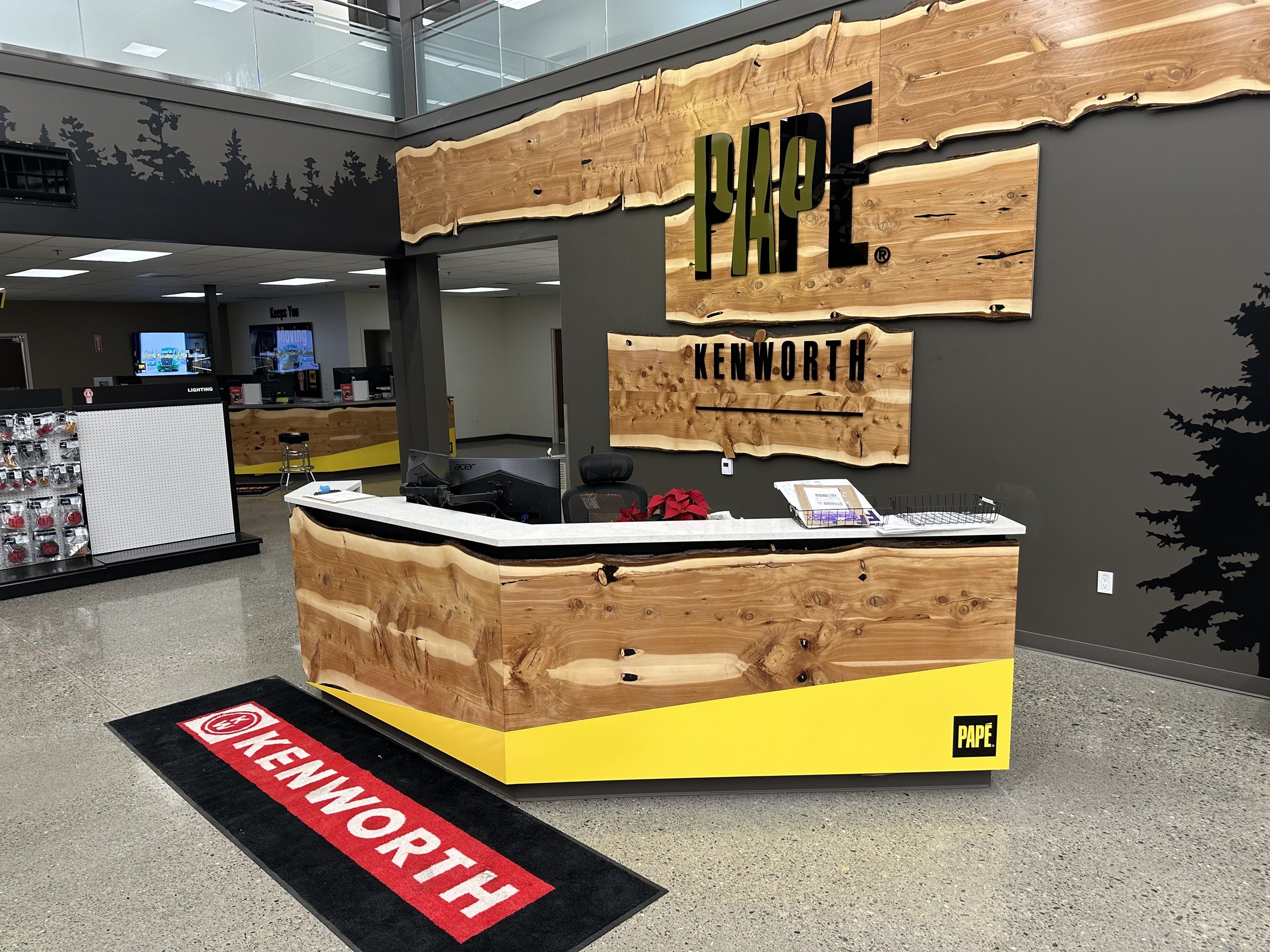 Custom fabricated desk with quartz top, juniper facing and ACM graphic details. Juniper slabs and 1/2" think black acrylic on the walls.—Federal Way, WA. 