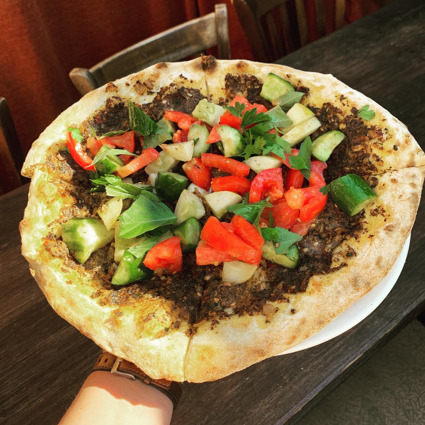 Lahmacun (pronounced lama-joun) is joining the menu! A dreamy vegan flatbread, spread with a paste of spiced crimini mushrooms and pine nuts and topped with fresh early girl tomatoes, cucumbers and herbs. Typically made with meat, this is a popular d