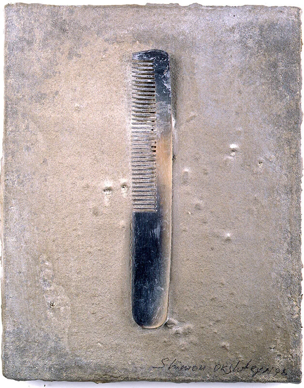 COMB Plastic comb on cement block, 10"x 8"  1998