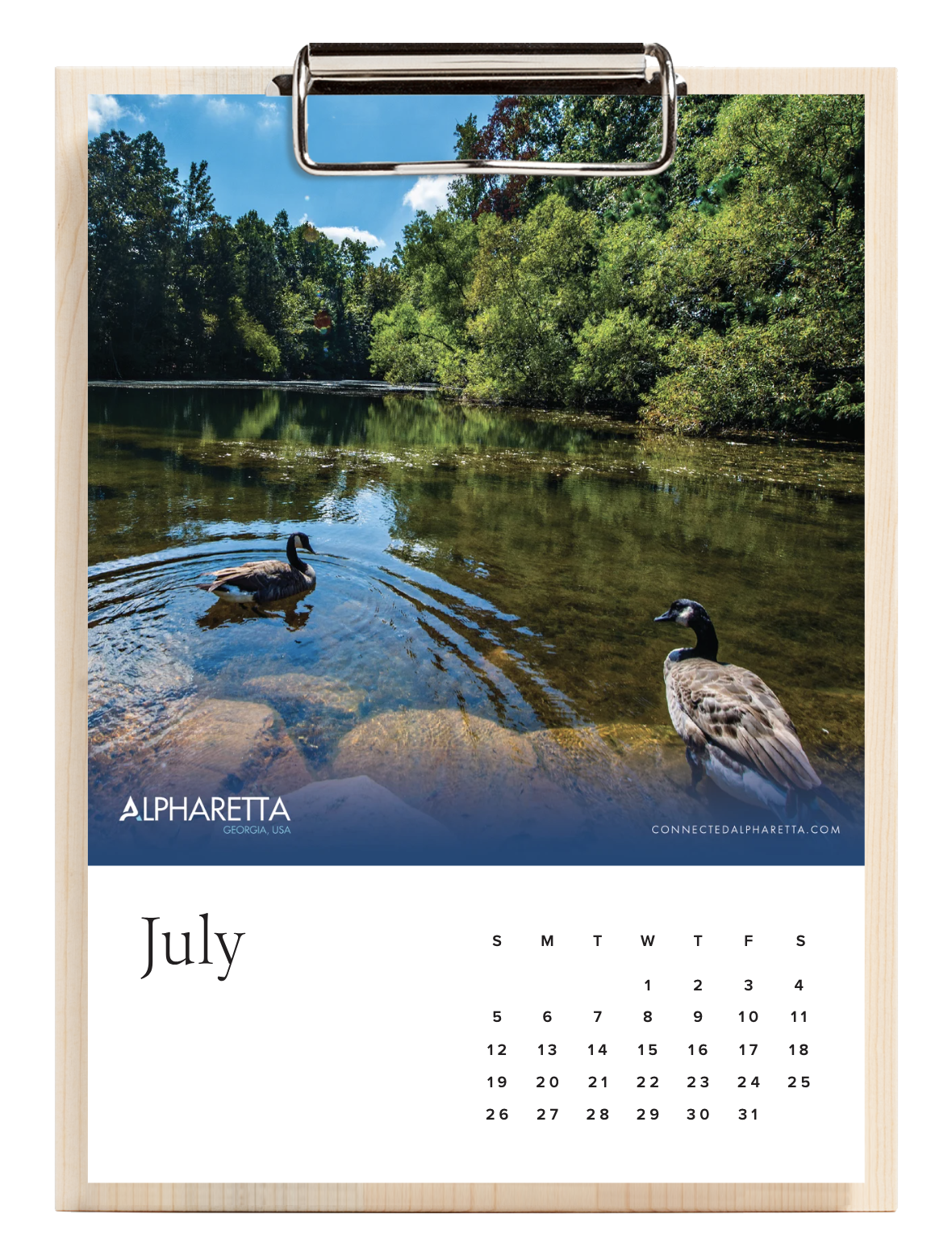 July month calendar with a nature photograph of two ducks swimming in a river surrounded by trees and blue sky, branded with Alpharetta, Georgia, USA, and connectedalpharetta.com.