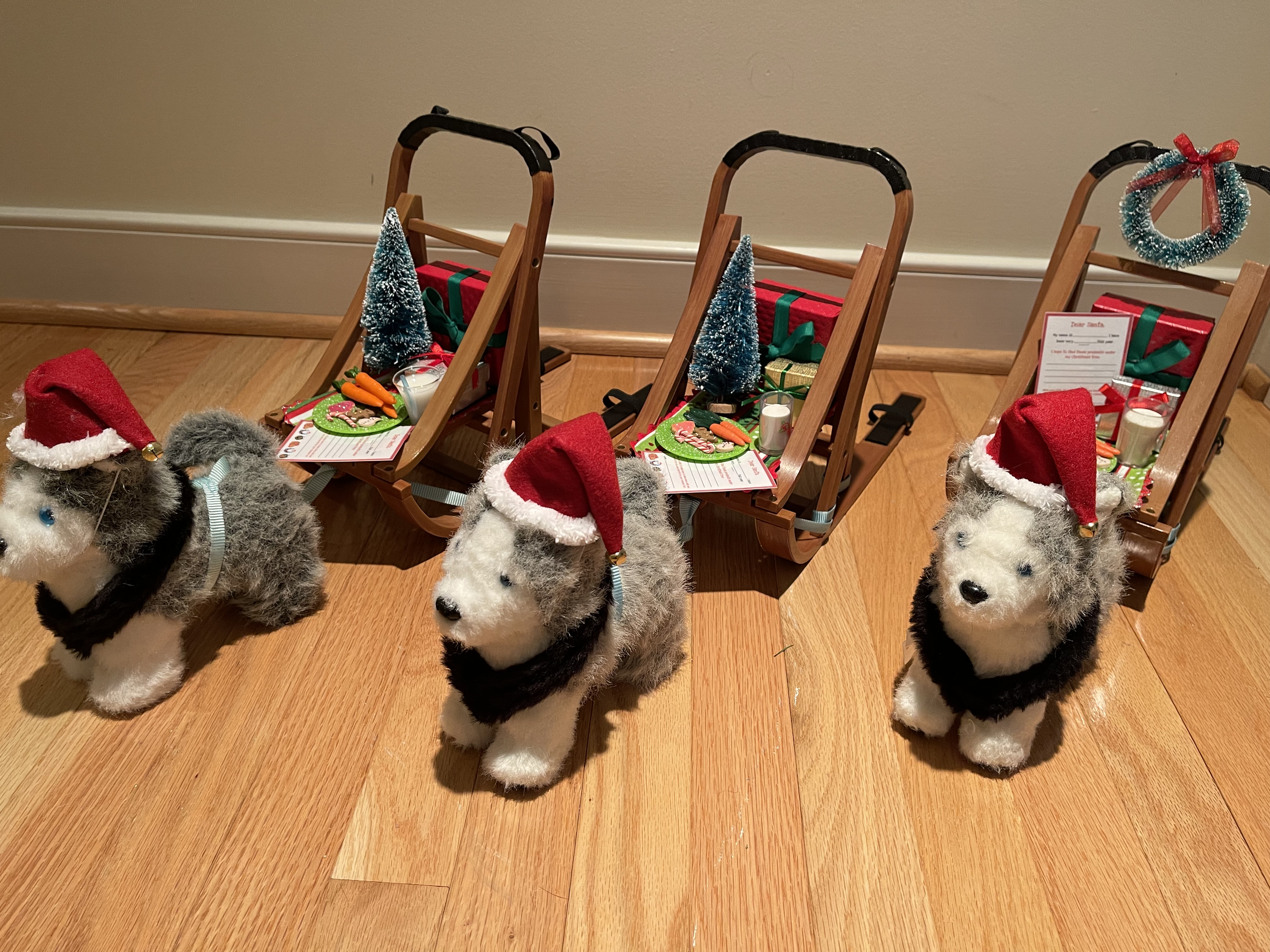 Upcycled American girl dog sleds. Included are packages, letter to Santa, trees, Christmas treats. There are foot straps on the bag for the doll to ride along. EACH sled is $56.