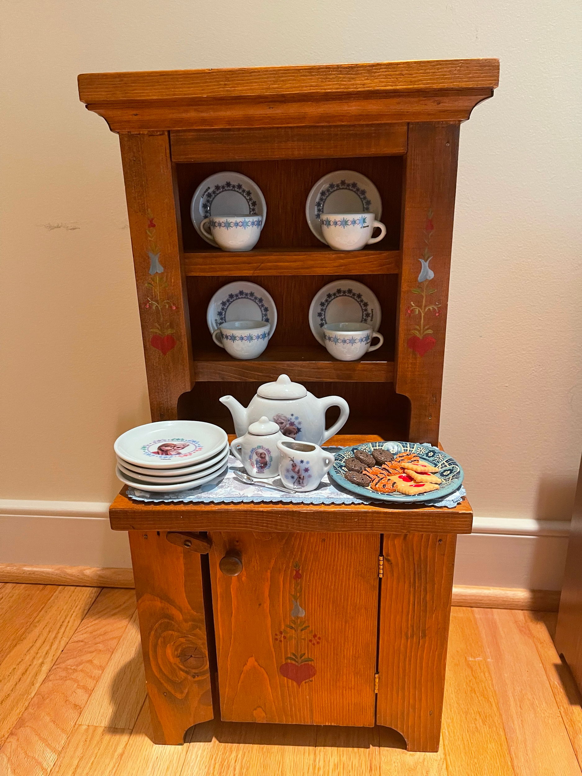 Larger cupboard with Frozen tea set and snacks. $86