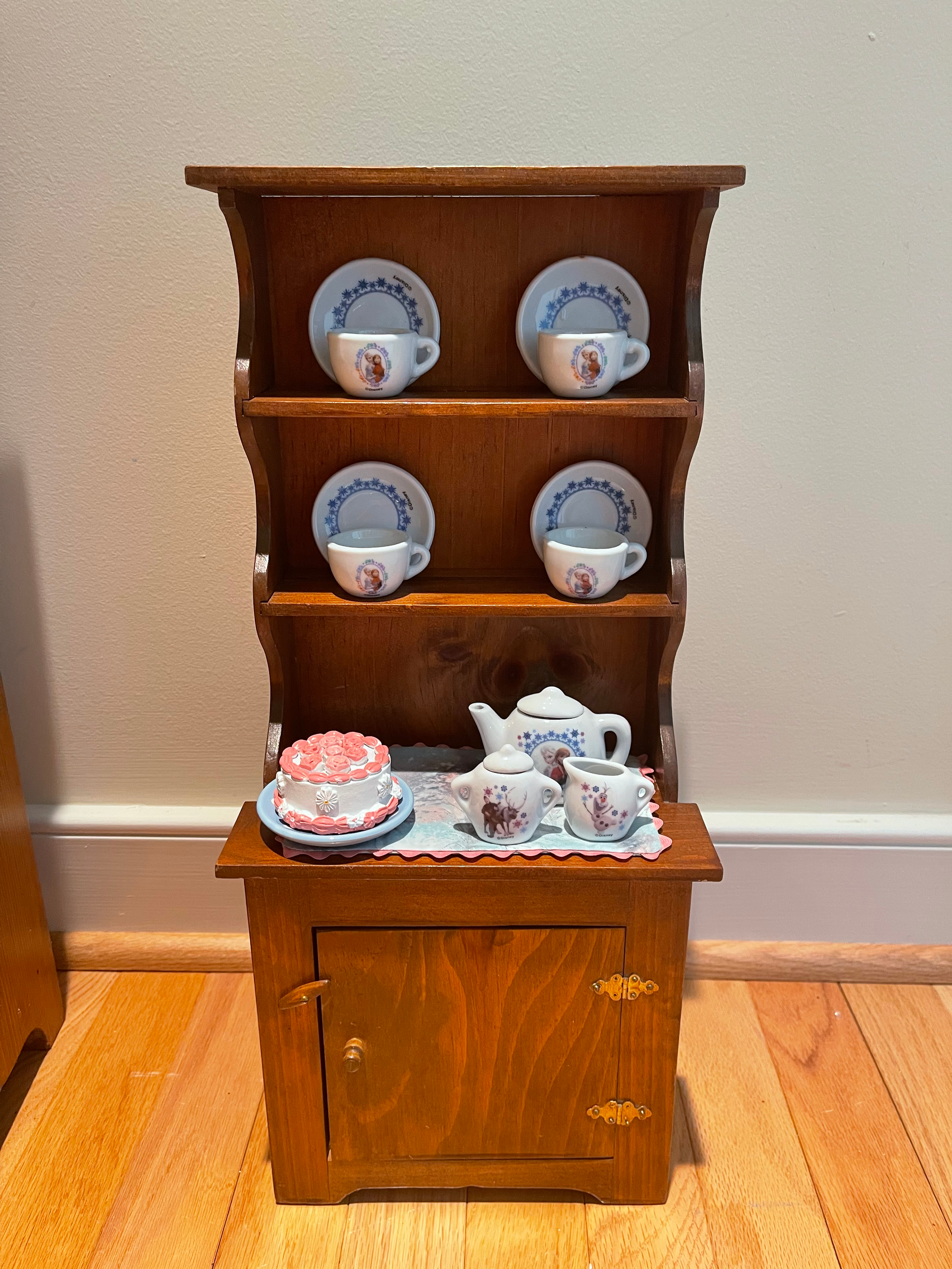 Cupboard with Frozen tea set. $62