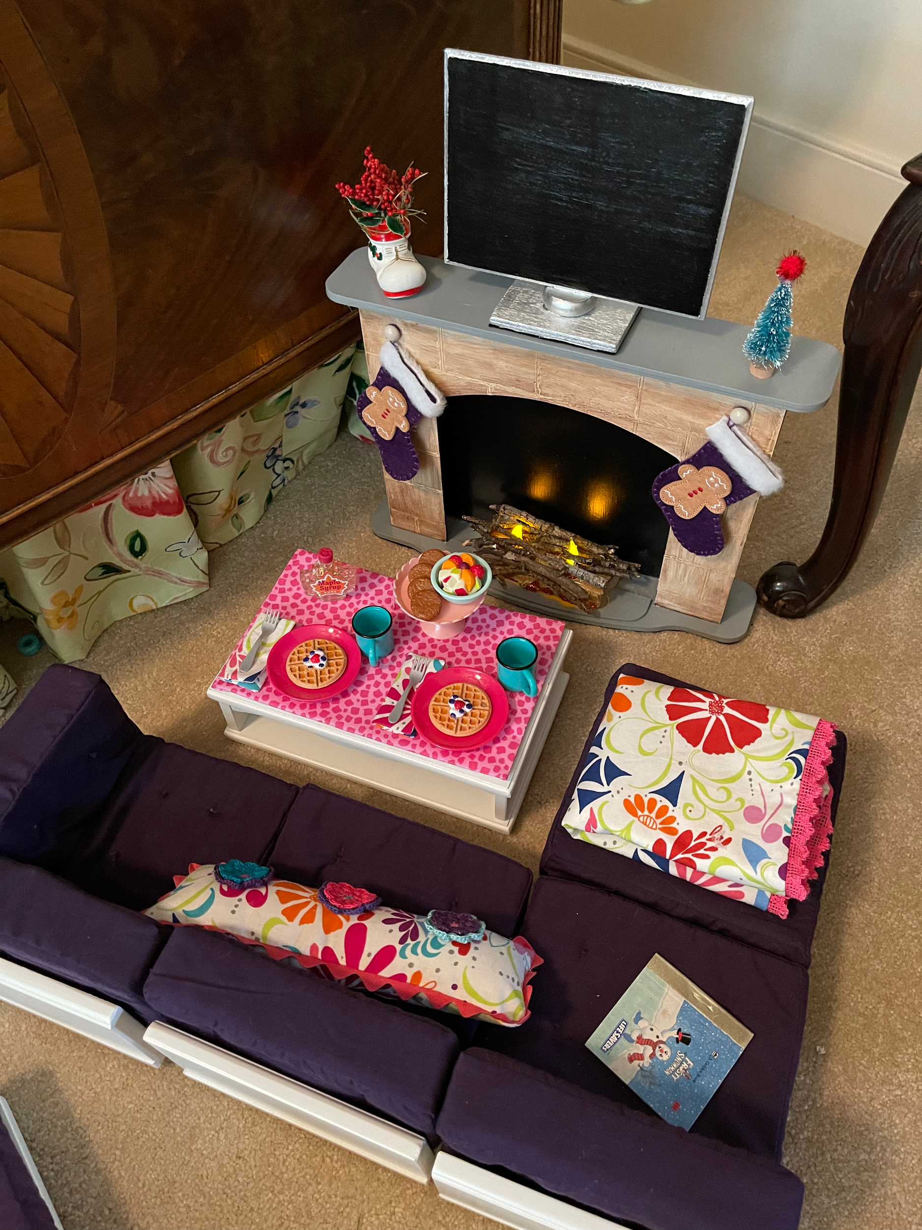 Holiday living area with lighted fireplace and TV. $148