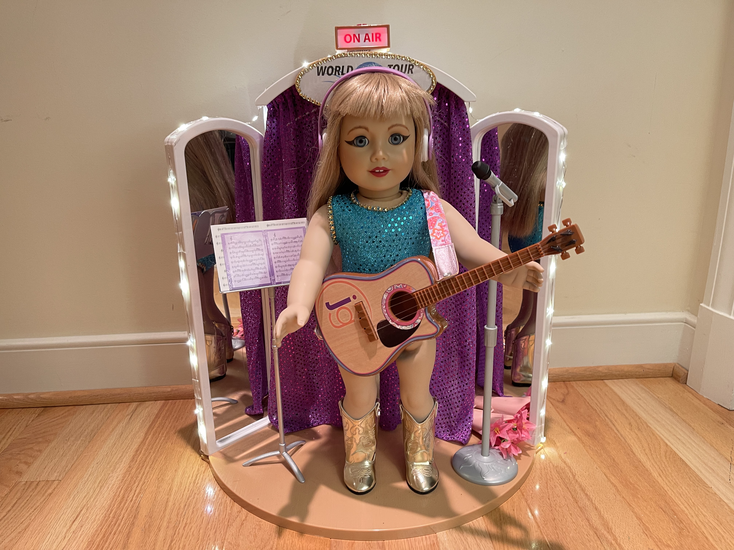 Pop Star 3. This item features a genuine up cycled American Girl doll. Her face has been beautifully painted and sealed with a beautiful make-up. Stage is lighted. Sparkly outfit and shiny boots are included. $210