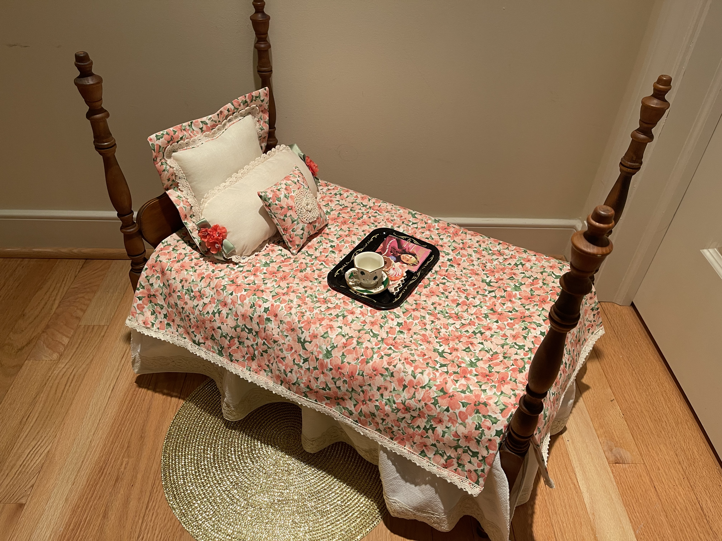 This vintage doll bed is perfect for an 18" doll. It features antique laces. Included is a tray with tea cup and cookies, along with an AG  magazine. $92