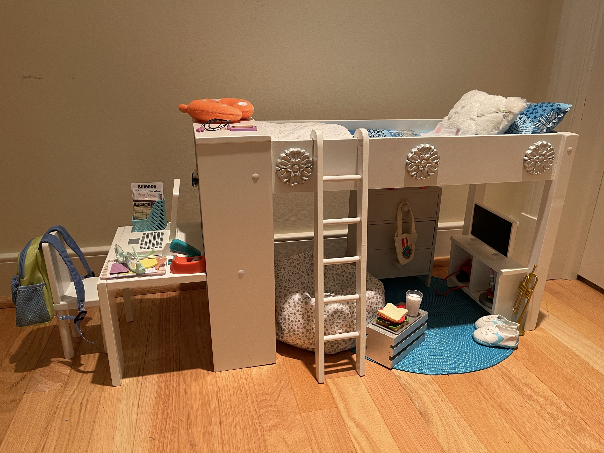 This loft bed features bedding, a bean bag chair for the TV area, a wooden dresser, a desk. School supplies, lunch, tennis rackets with balls, shoes, a few other extras are all included. $136