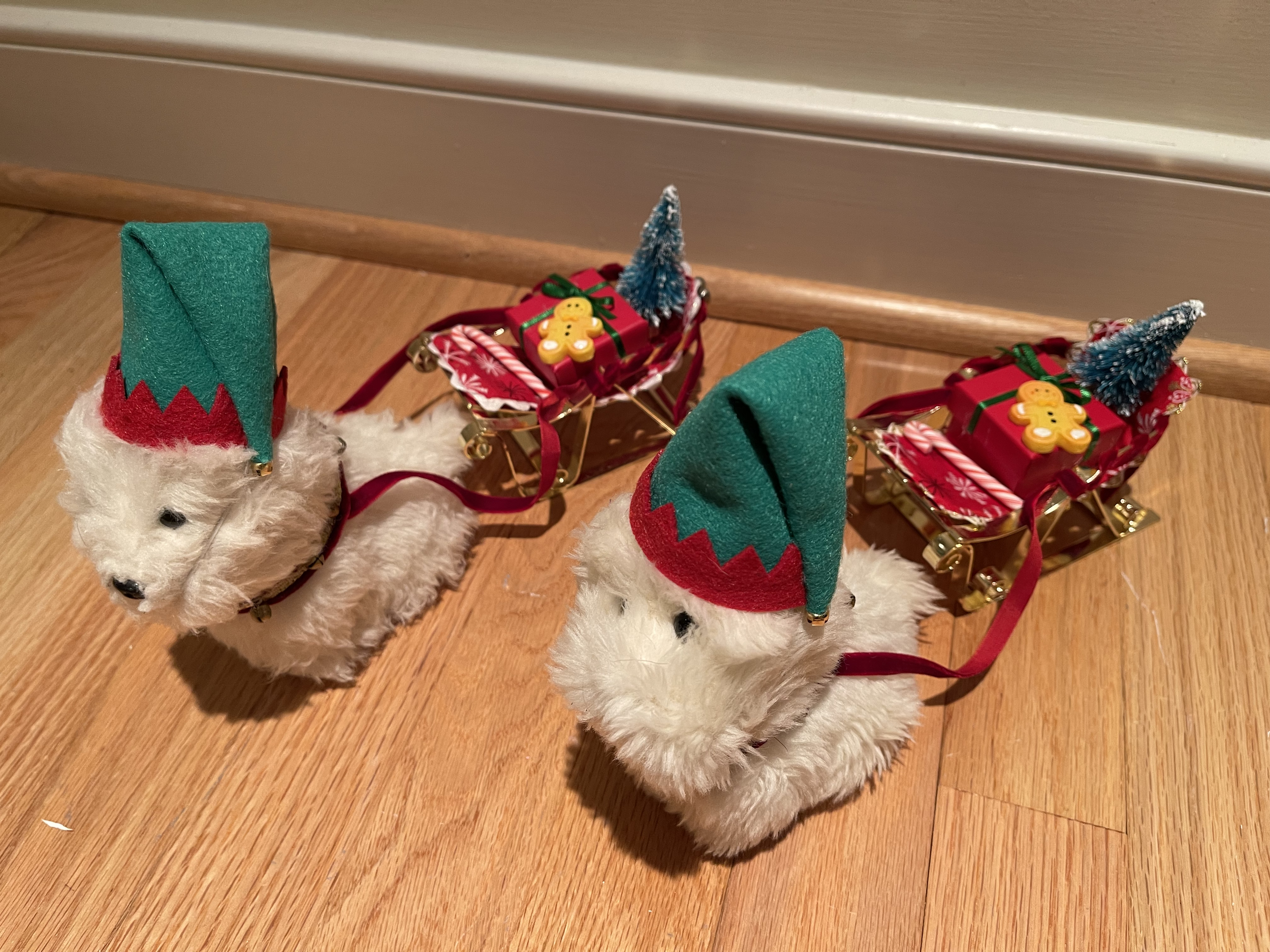 AG Coconut dog sleds complete with a present, small tree, and Christmas treats. EACH dog and sled is $42.