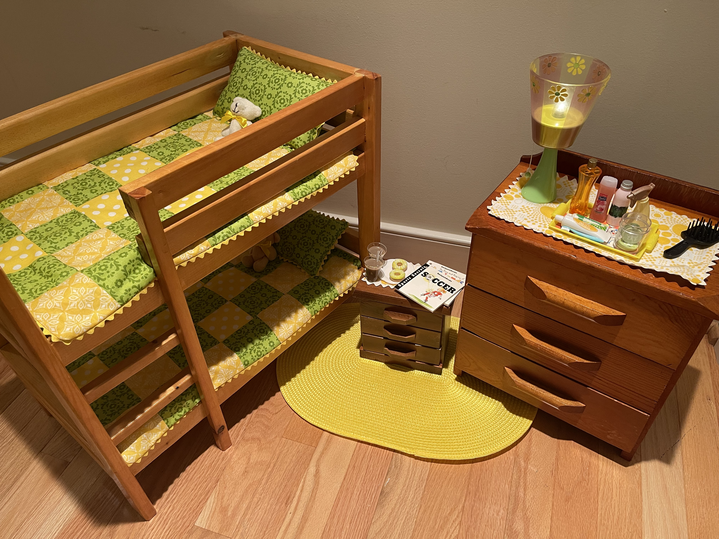 This bedroom set features sturdy vintage furniture. Bunk beds, nightstand, and spacious dresser are all included. Lamp does work. Included are various toiletries, books, and a snack. $164