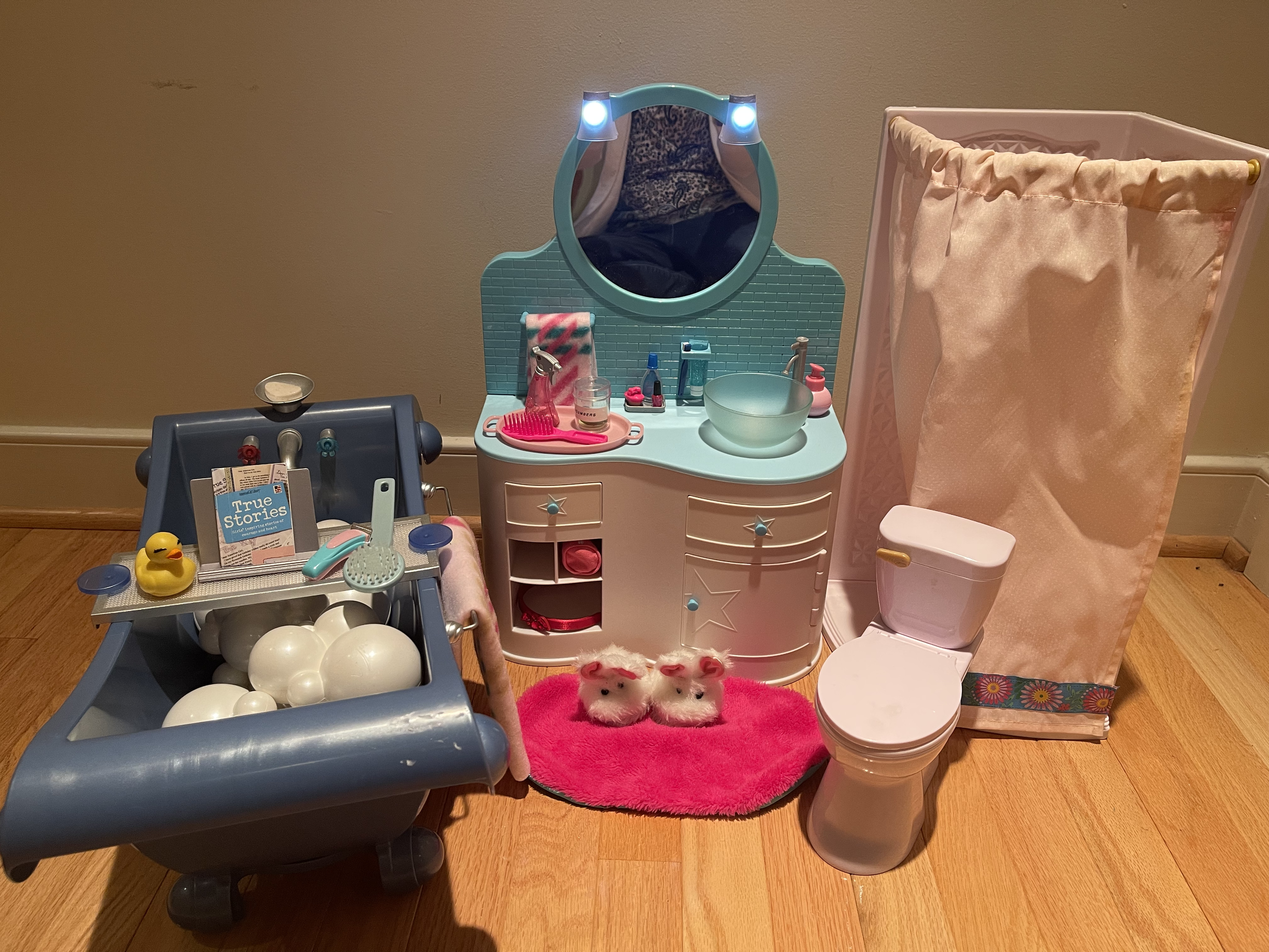 This bathroom features a light-up vanity and a toilet that makes flushing sounds. Included are bath, shower, sink, and lots of hair accessories. $98