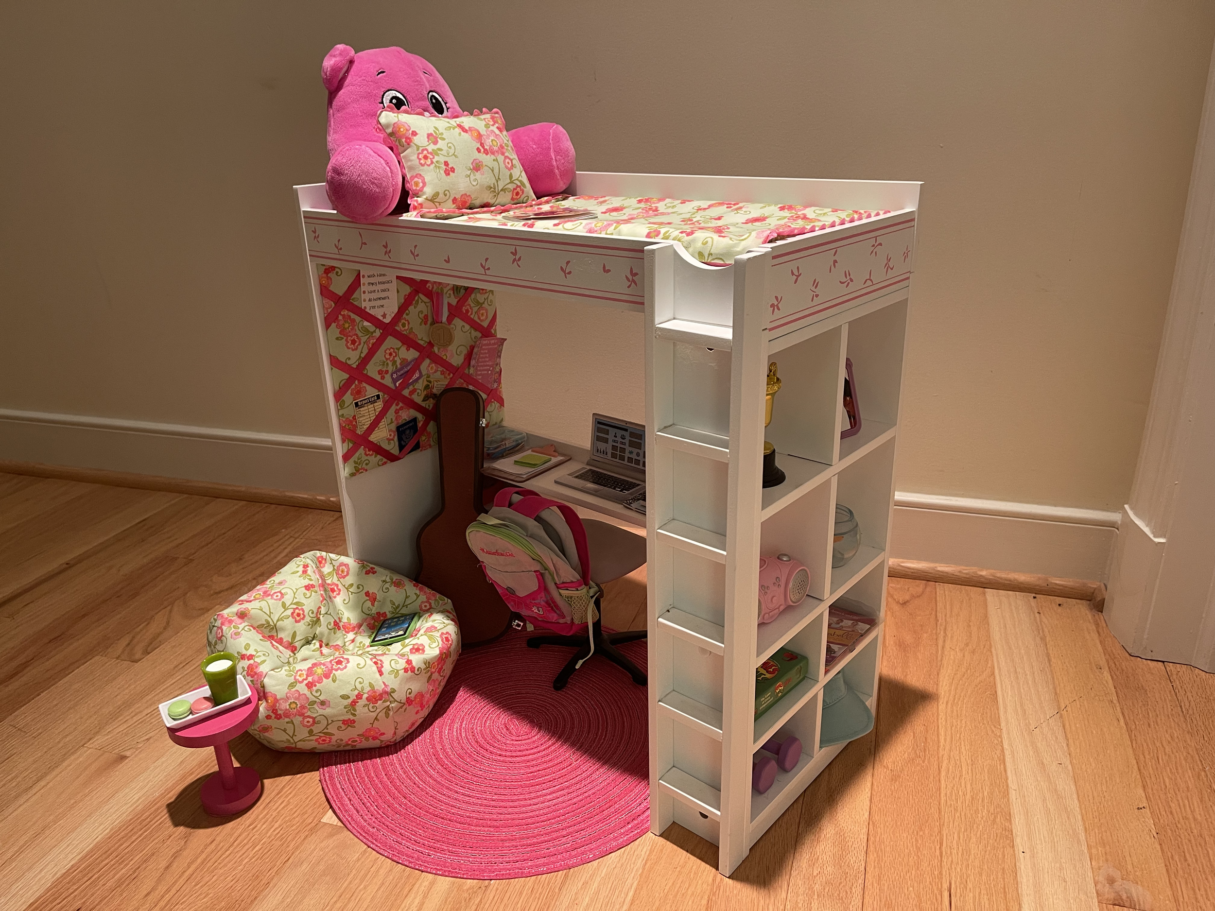 This loft bed features bedding, a bulletin board, beanbag chair, lots of school accessories, a guitar and case, backpack, and miscellaneous fun items. $124